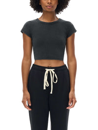 Women wearing a snow washed crop top with round neck and drop shoulder sleeves in casual streetwear style