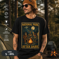 National Park After Dark t-shirt showing campfire, moonlit trees, Sasquatch, and Mothman creatures in vintage style