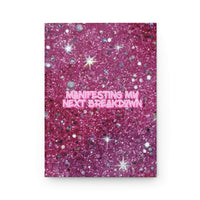 Hardcover journal with pink glittery matte cover titled "Manifesting My Next Breakdown"