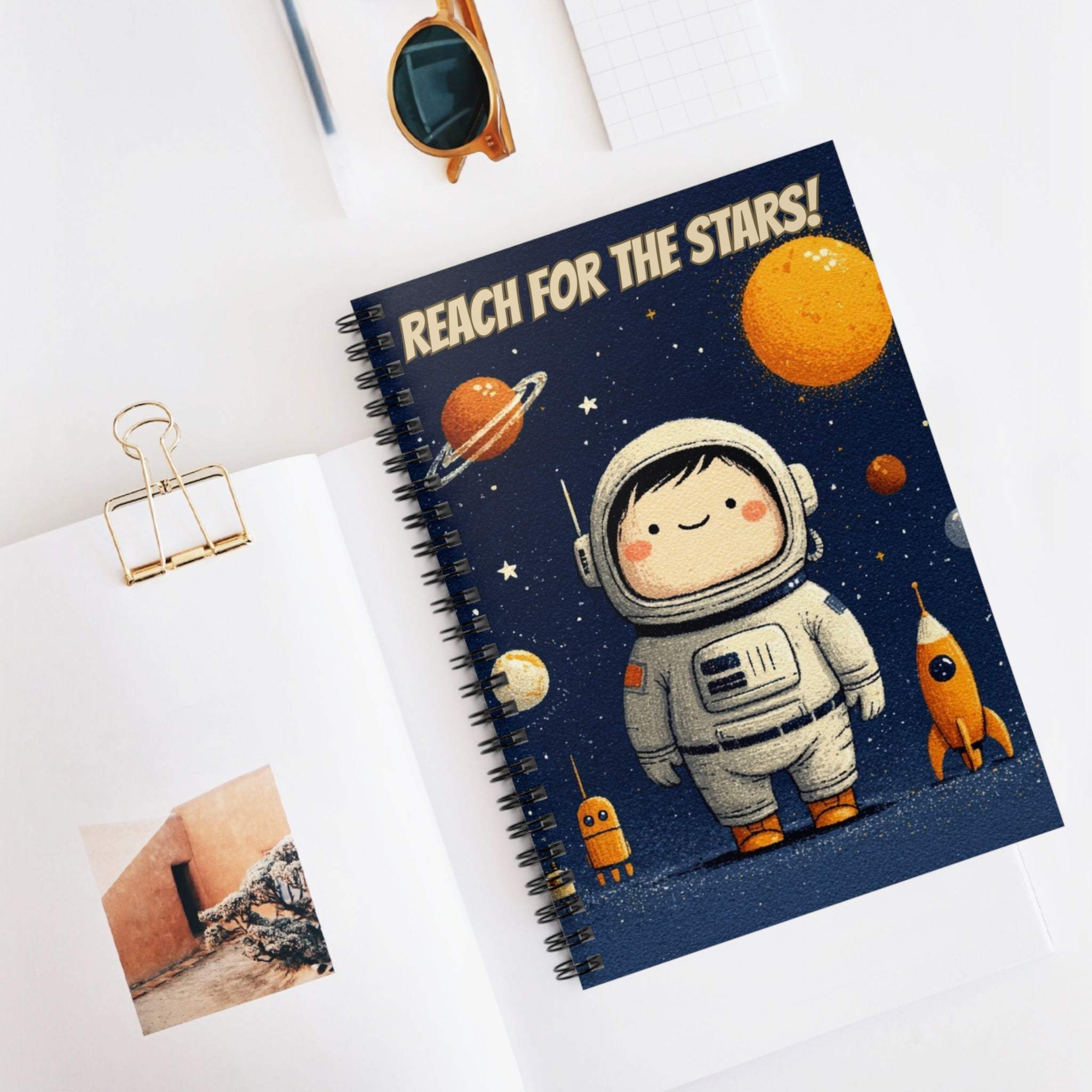 Spiral notebook with Reach for the Stars astronaut design and metal binding for space enthusiasts