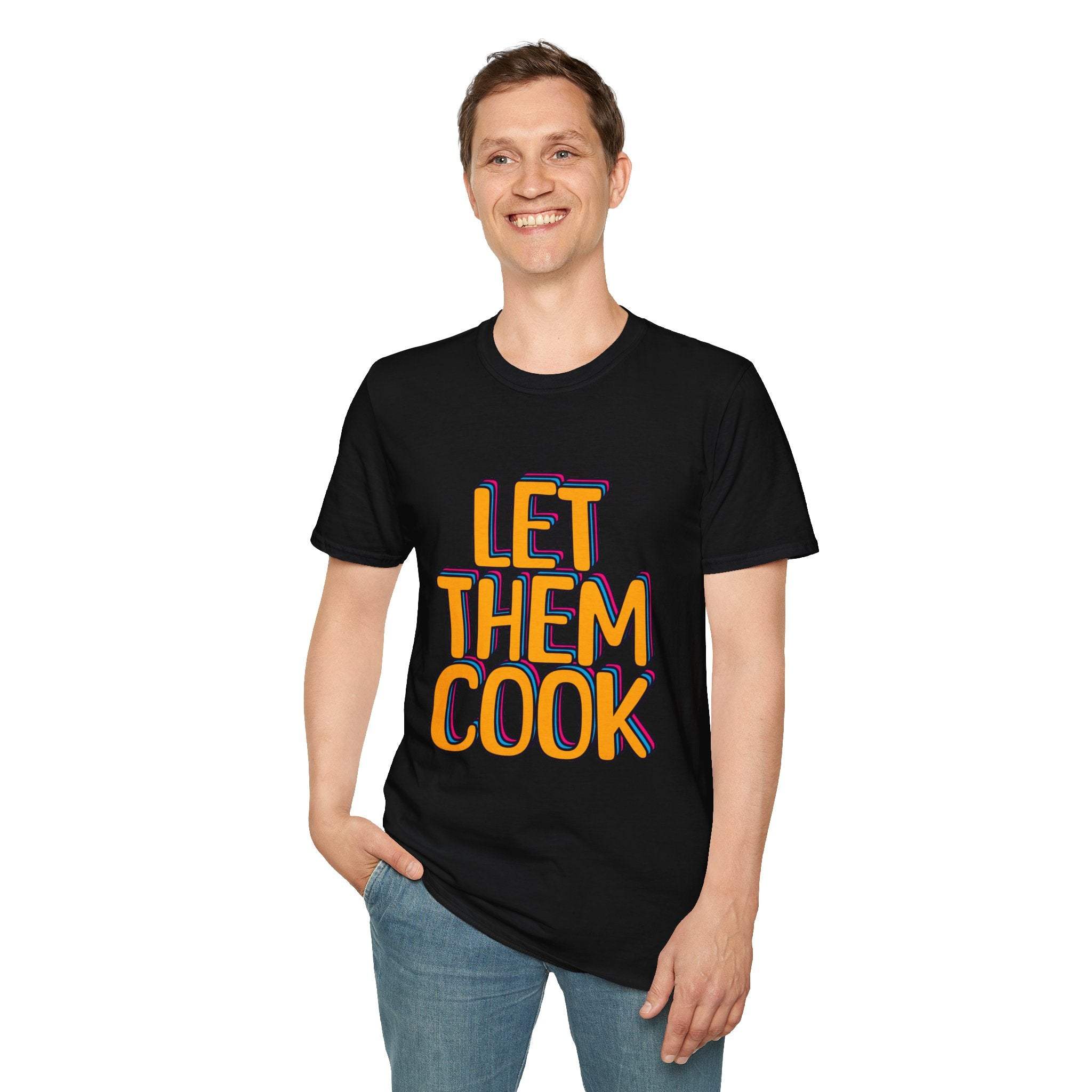 Man wearing black Let Them Cook T-shirt with colorful bold lettering and casual fit