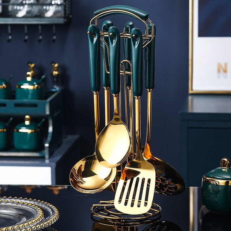 7-piece stainless steel and silicone kitchen utensil set with slotted spatula, ladle, serving spoon, and pasta server on a gold stand