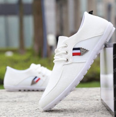 Men's soft-soled white canvas shoes with low heel and color stitching detail for casual wear