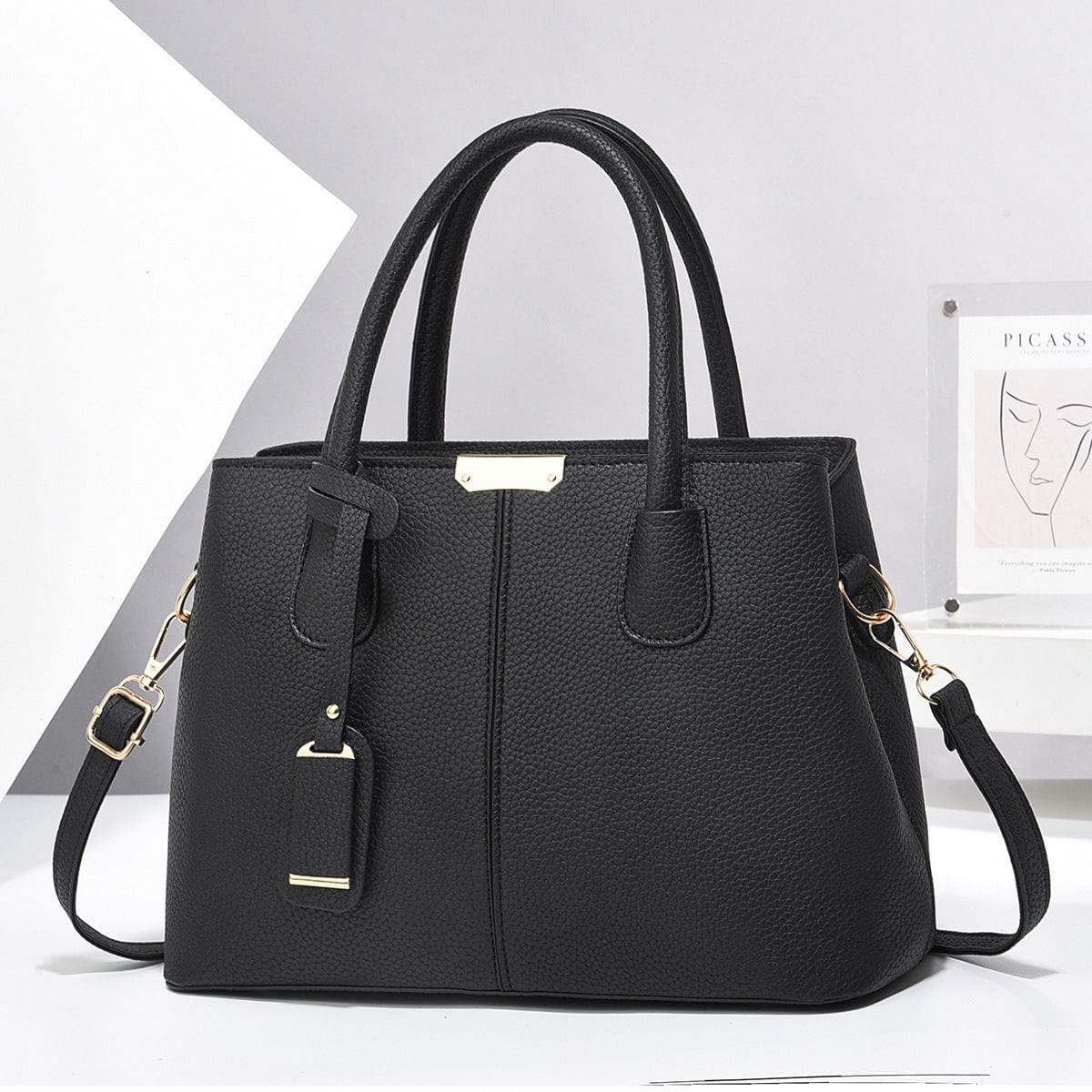 Black women PU leather handbag with large capacity, square shape, dual handles, and detachable shoulder strap.