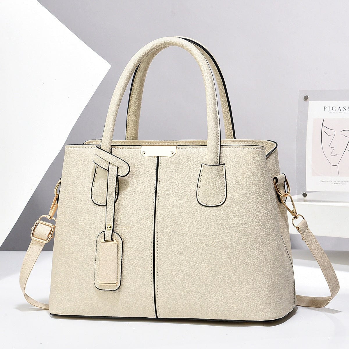Cream-colored women PU leather handbag with large capacity and square shape, featuring double handles and a detachable shoulder strap.