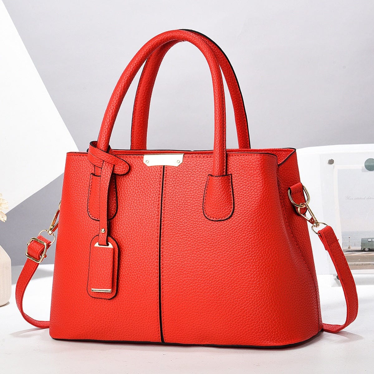 Red women PU leather handbag with large capacity, square tote design, and single shoulder strap.