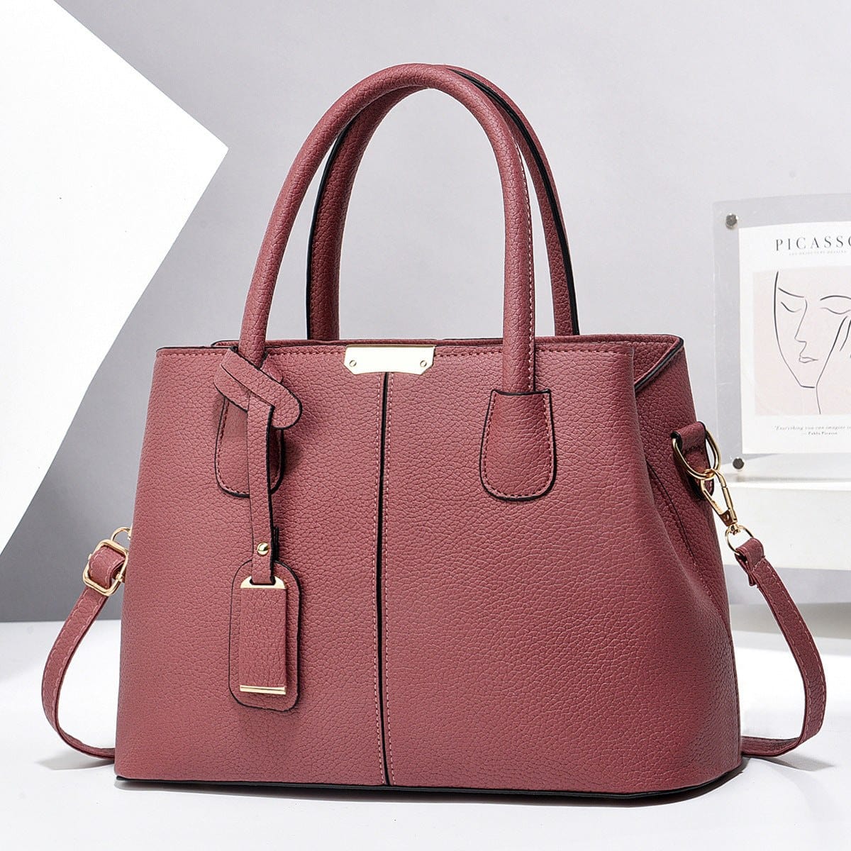 Women PU leather handbag in maroon with large capacity, dual handles, and detachable shoulder strap, stylish and high quality tote bag
