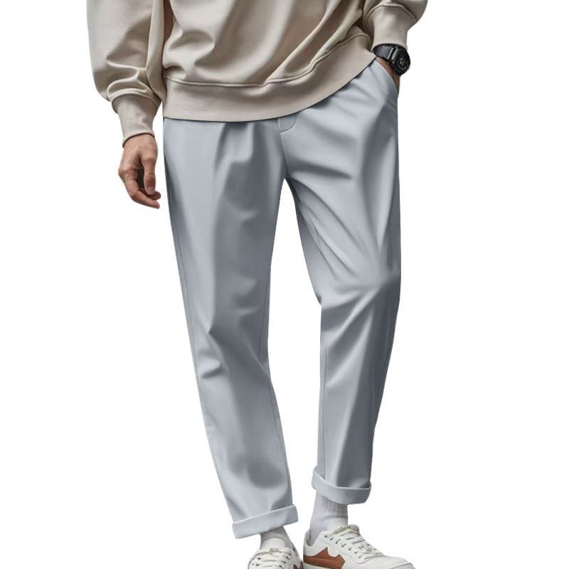 Men's light gray casual loose fit trousers with pockets and drawstring waist, paired with beige sweatshirt and white sneakers