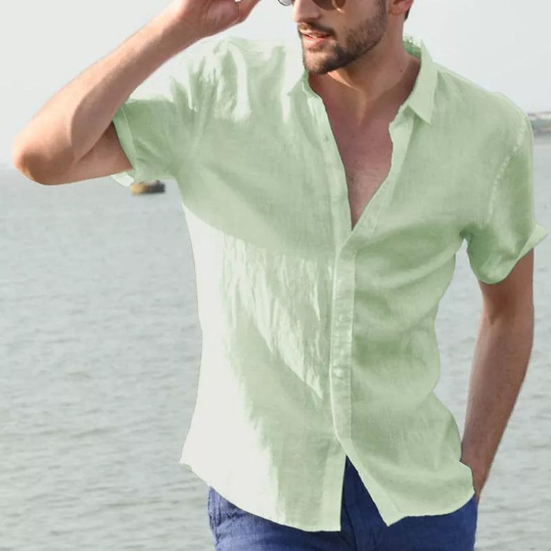 Man wearing a light green summer short-sleeved button-up casual shirt with lapel collar by the water