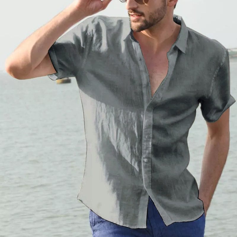 Man wearing gray summer short-sleeved casual button shirt with lapel collar by the water