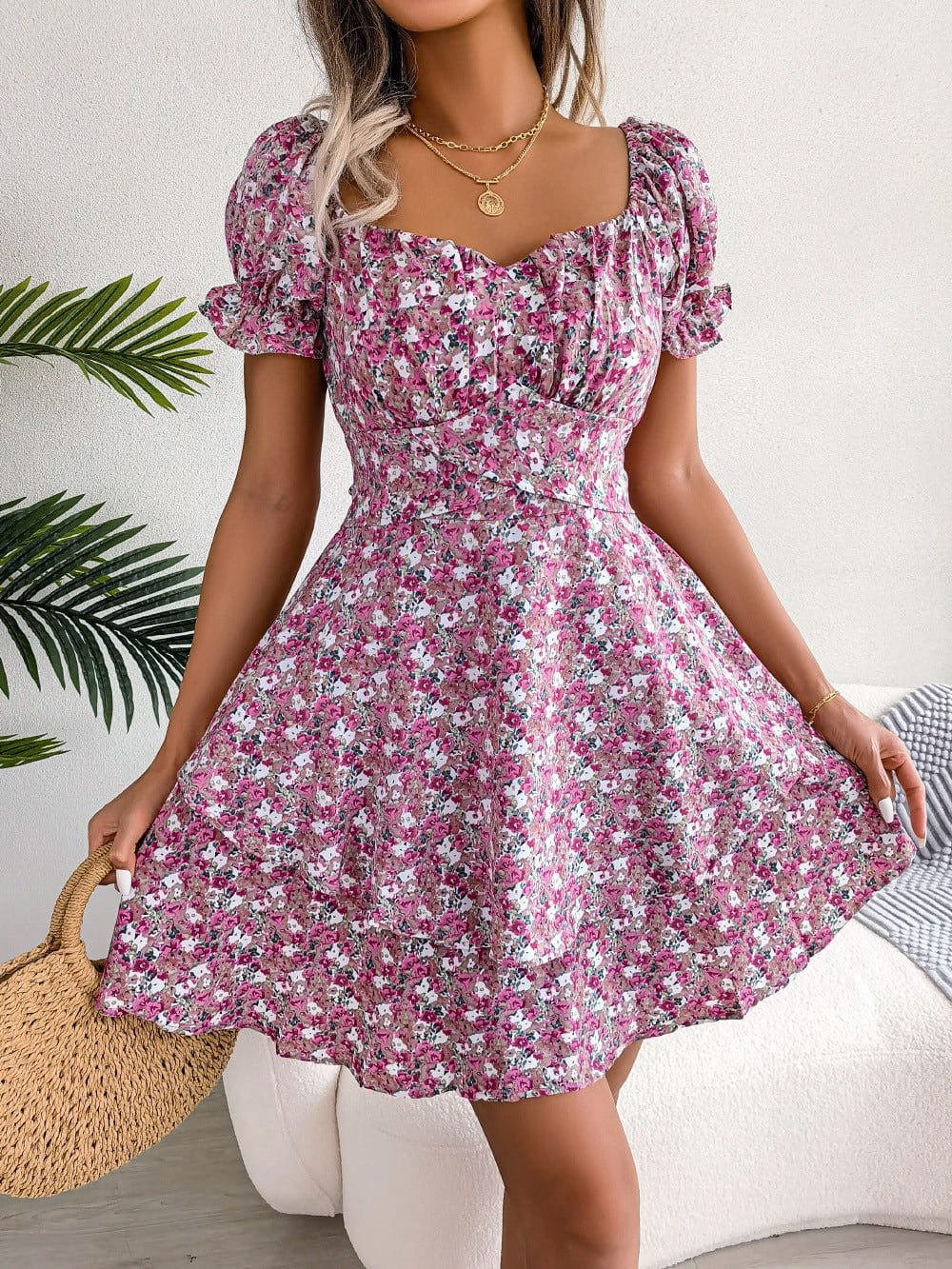 Women mini dress with pink floral print, short sleeves, loose swing hem, and mid-waist A-line silhouette.