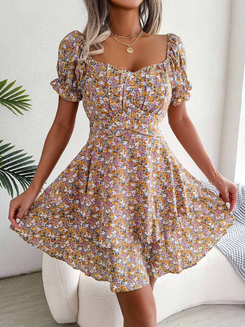 Women mini dress with floral print, puff short sleeves, high waist, and loose A-line hem.