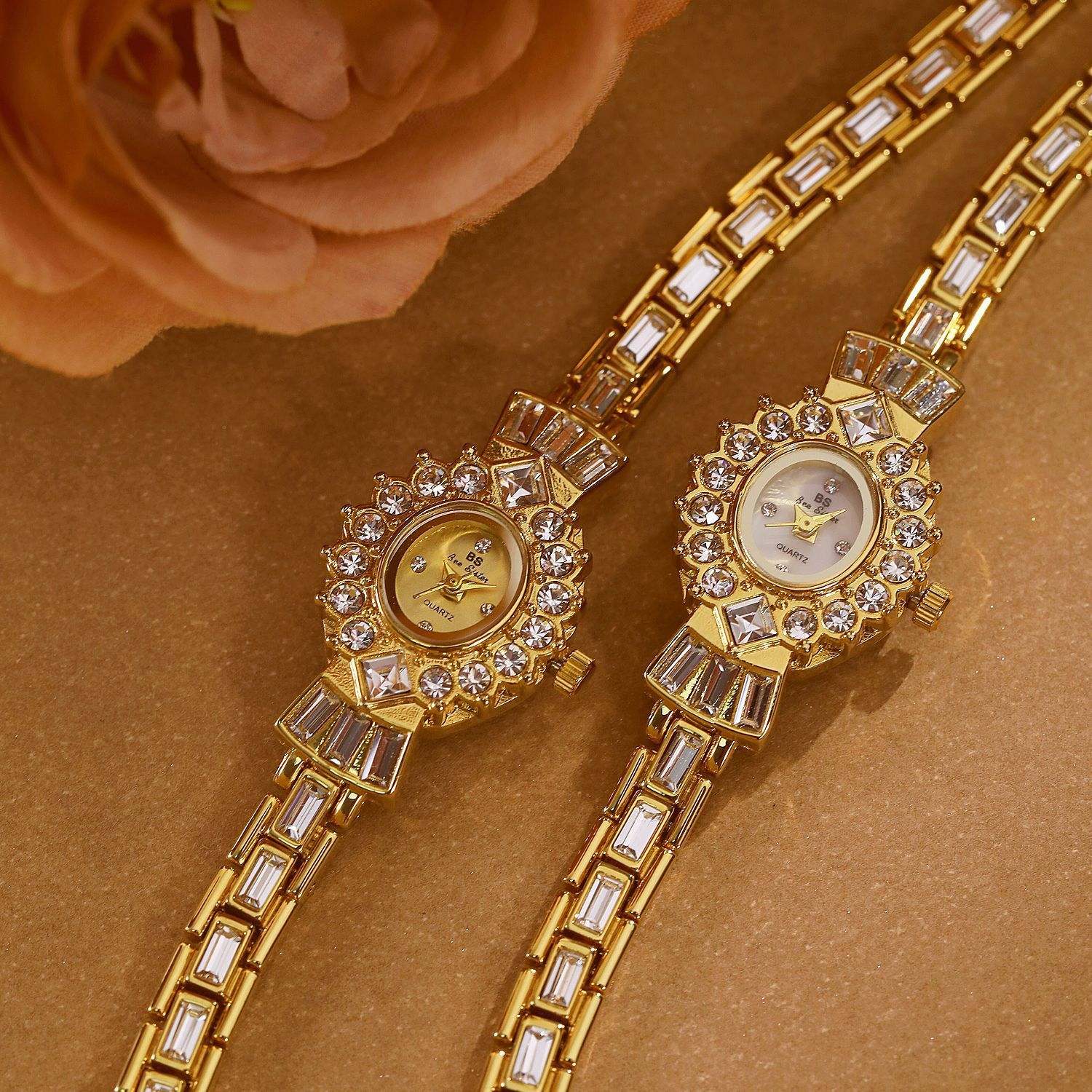 Pair of women's diamond middle-ancient magic mirror watches with gold and white barrel-shaped dials and jeweled gold straps