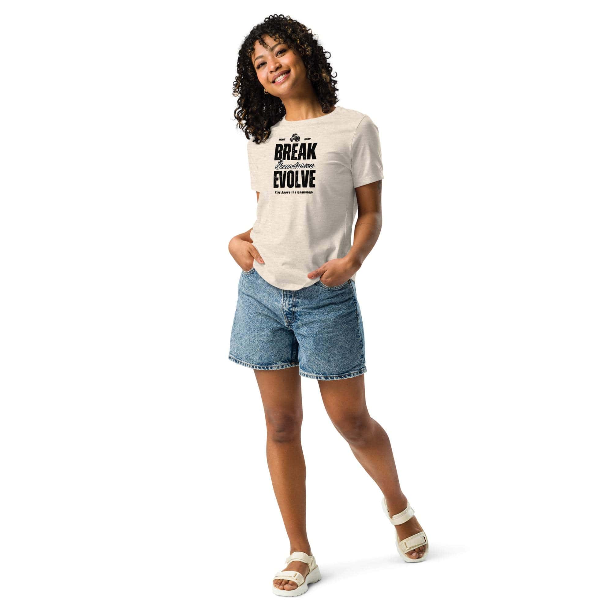 Woman wearing Break Boundaries Evolve T-Shirt with inspirational quote, paired with denim shorts and white sandals
