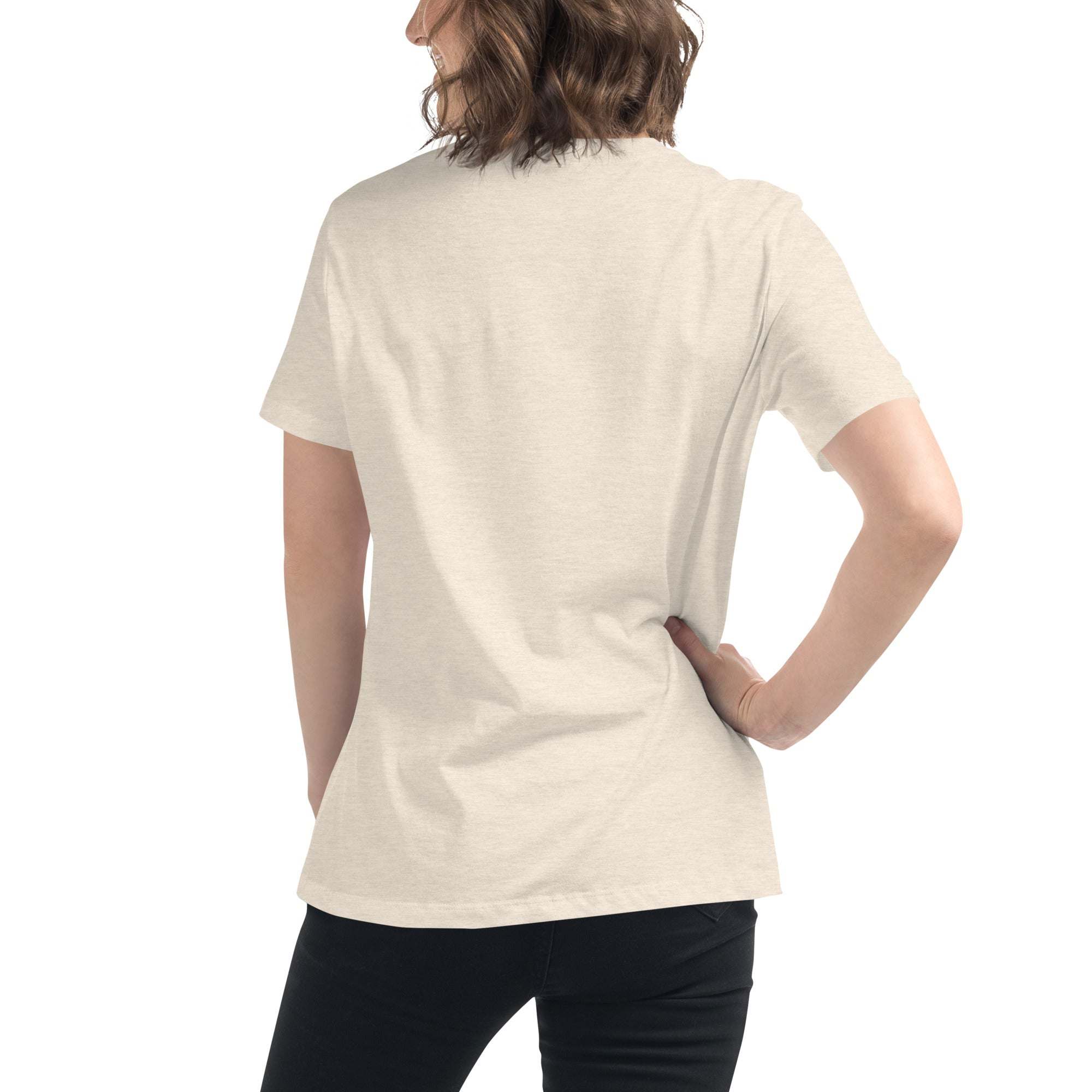 Back view of a woman wearing a beige Music Girl T-Shirt with soft fabric and short sleeves, paired with black pants.