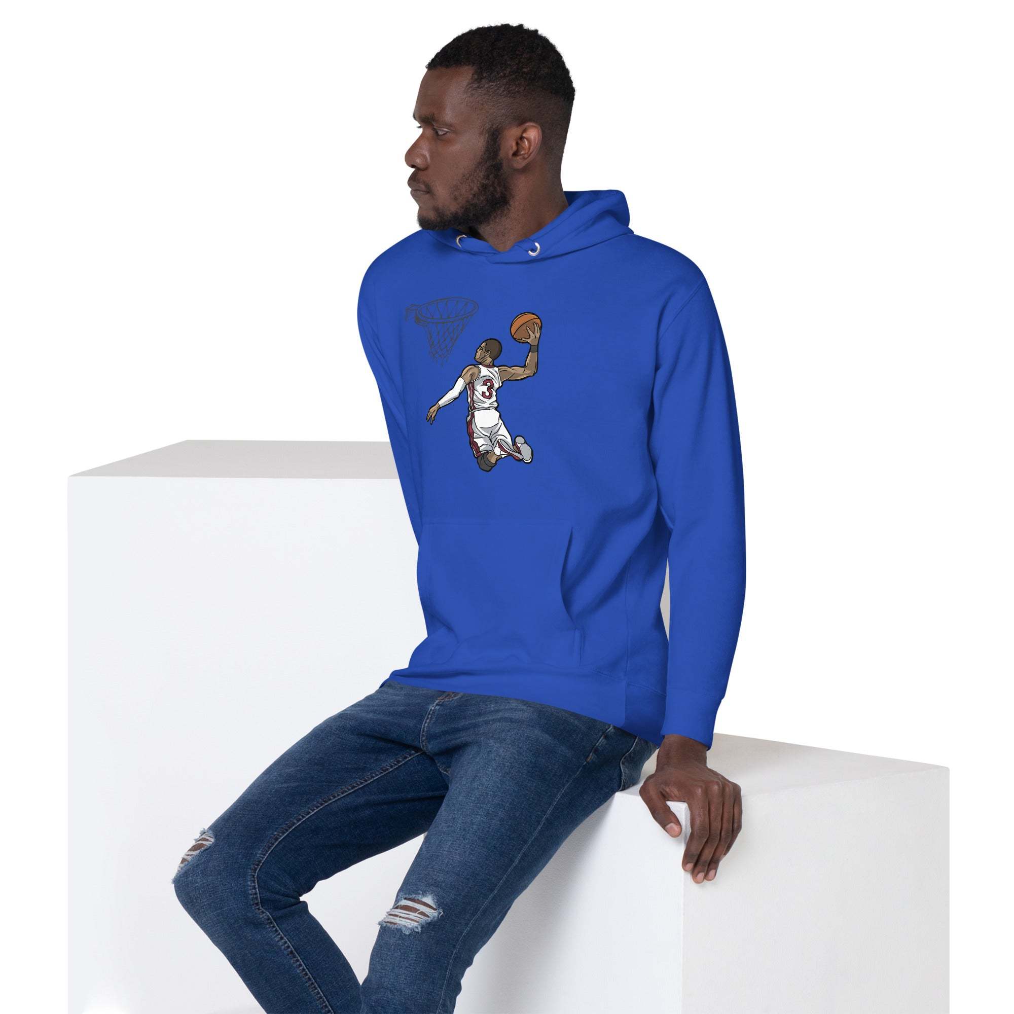 Man wearing blue Basketball Dunk Hoodie with slam dunk graphic sitting on white block