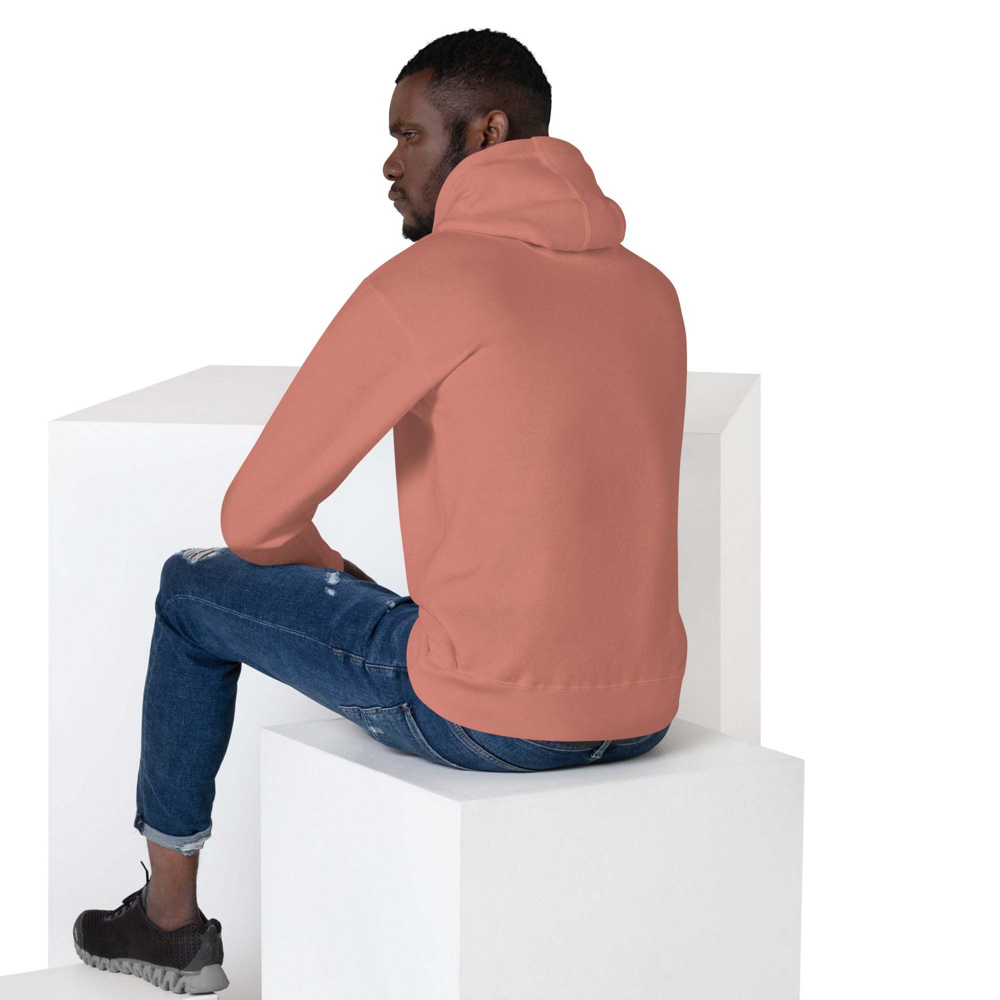 man wearing basketball dunk hoodie unisex athletic pullover sitting on white block back view