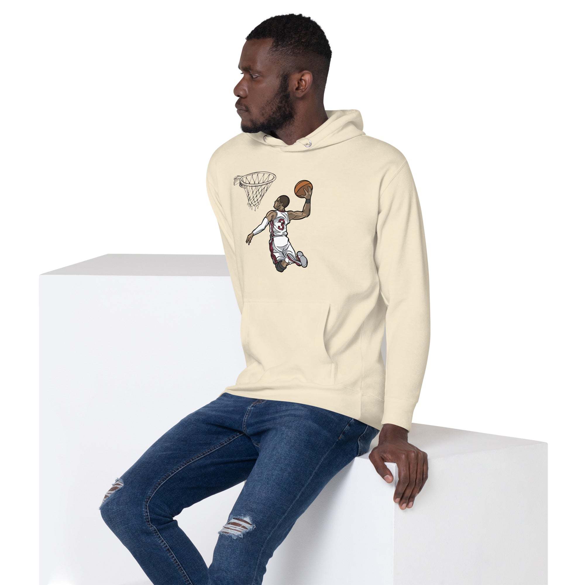 Man wearing Basketball Dunk Hoodie with slam dunk graphic sitting on white block