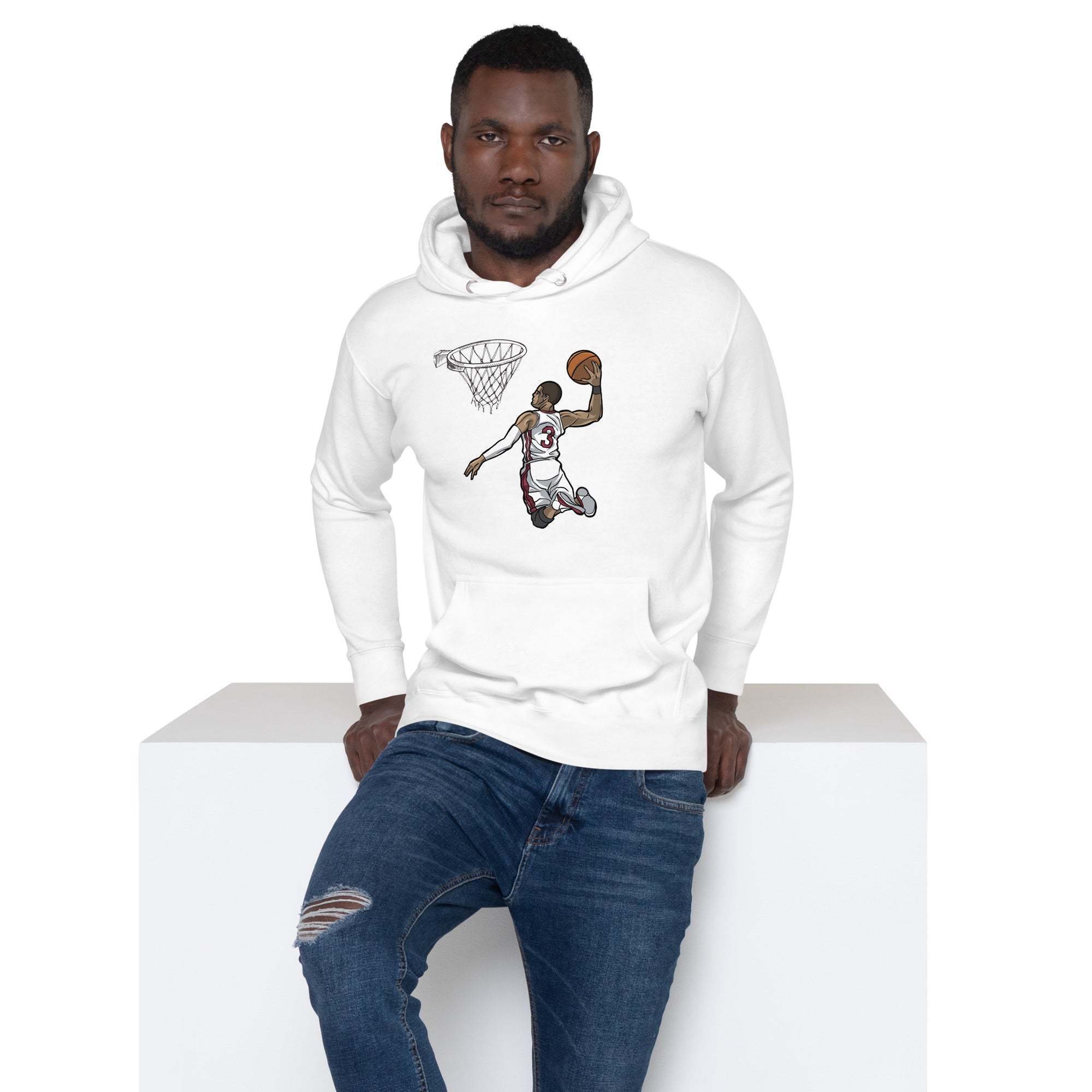 Man wearing white unisex Basketball Dunk Hoodie with slam dunk graphic and blue jeans sitting on white block
