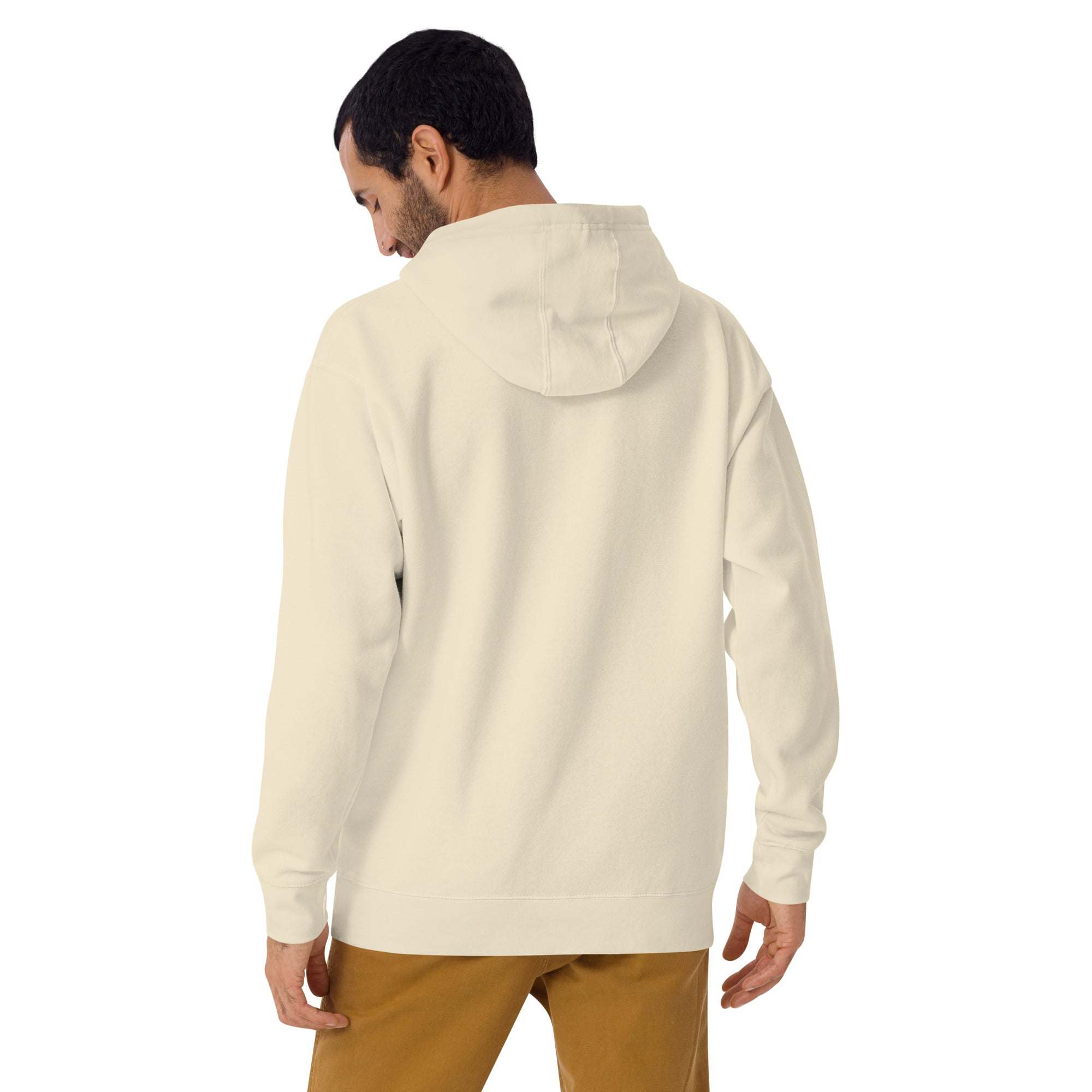 back view of man wearing beige Keep Seeking Growth Hoodie with hood up and brown pants