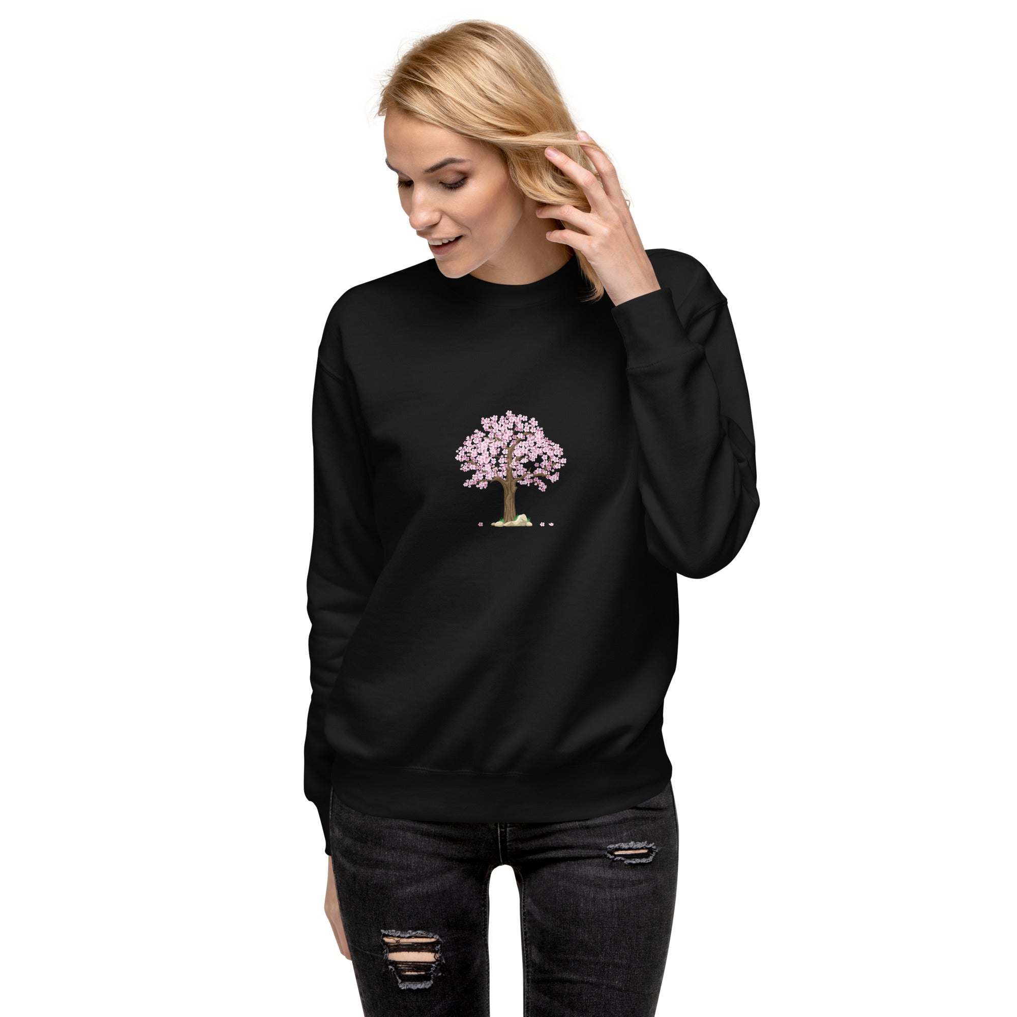 Woman wearing black unisex sweatshirt with pink cherry blossom tree design on front