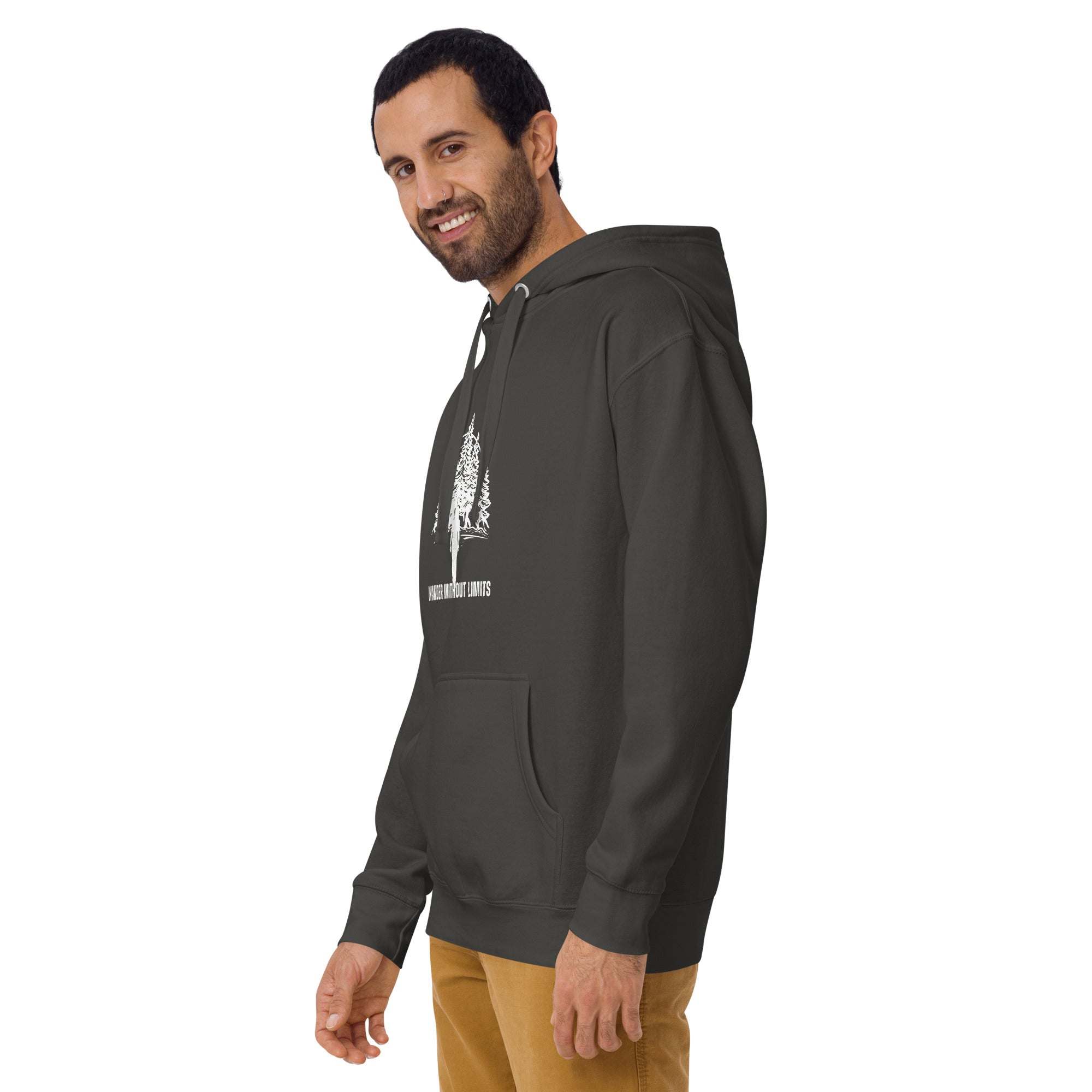 man wearing dark green Wander Without Limits Hoodie with wilderness graphic and beige pants