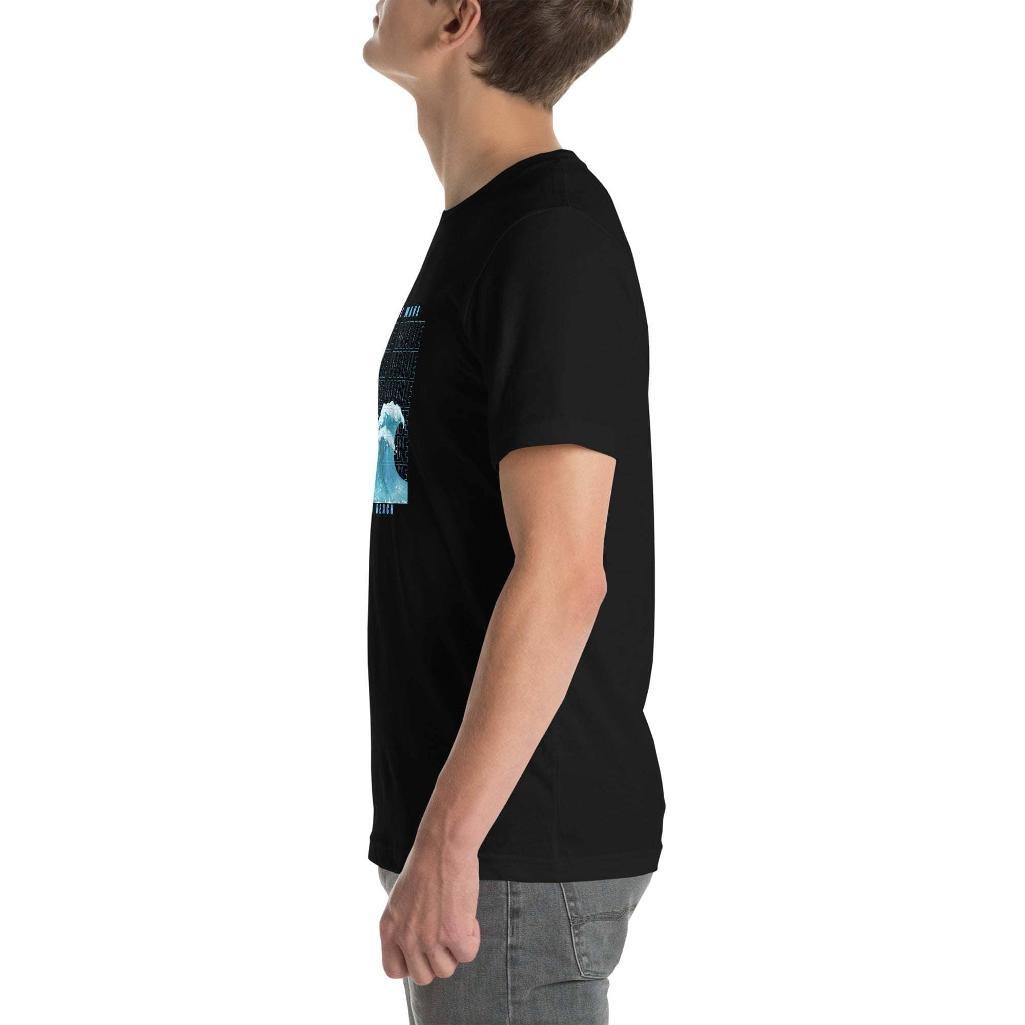 Side view of a man wearing a black Ride the Wave T-Shirt with a blue wave design, styled for a casual coastal look