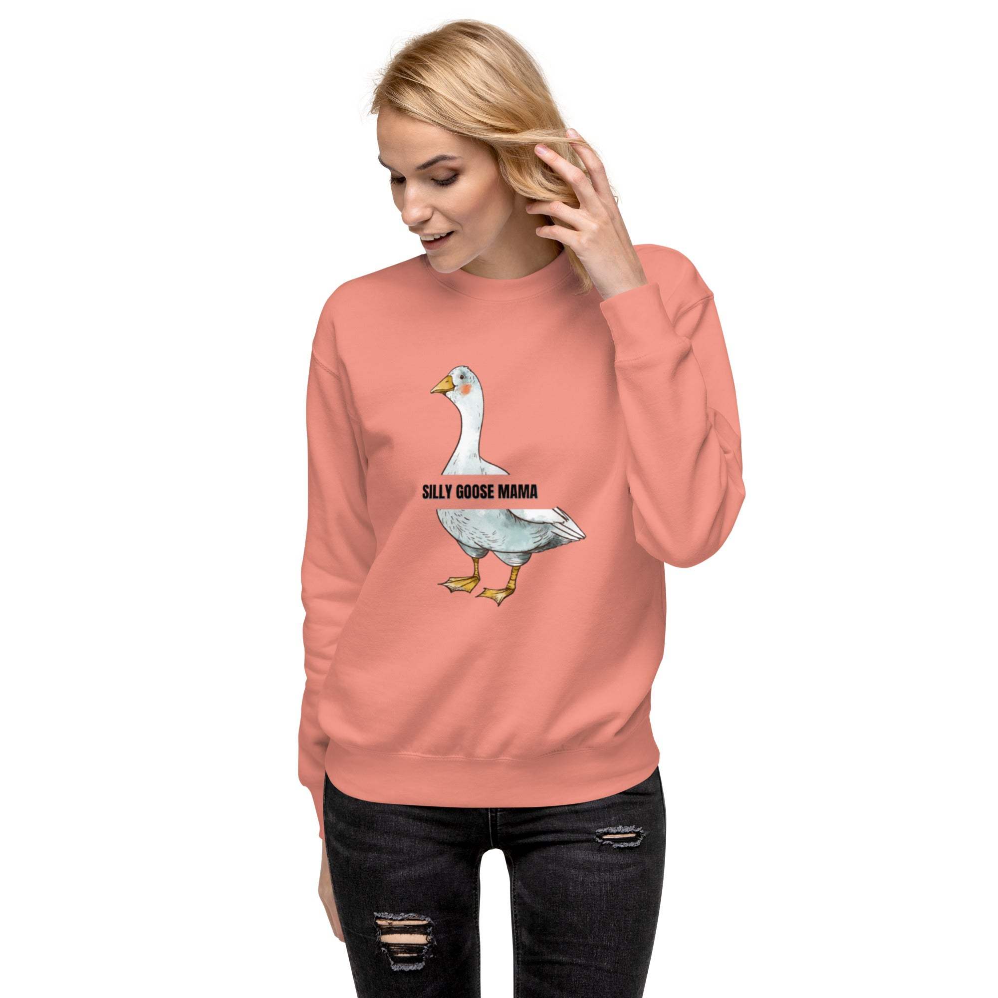 Woman wearing a pink Silly Goose Mama Sweatshirt with goose illustration and text on front