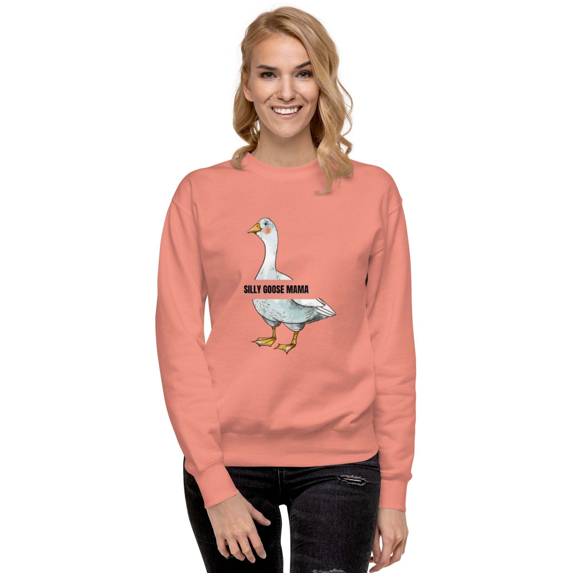 Woman wearing a pink Silly Goose Mama Sweatshirt with a goose illustration and text on the front