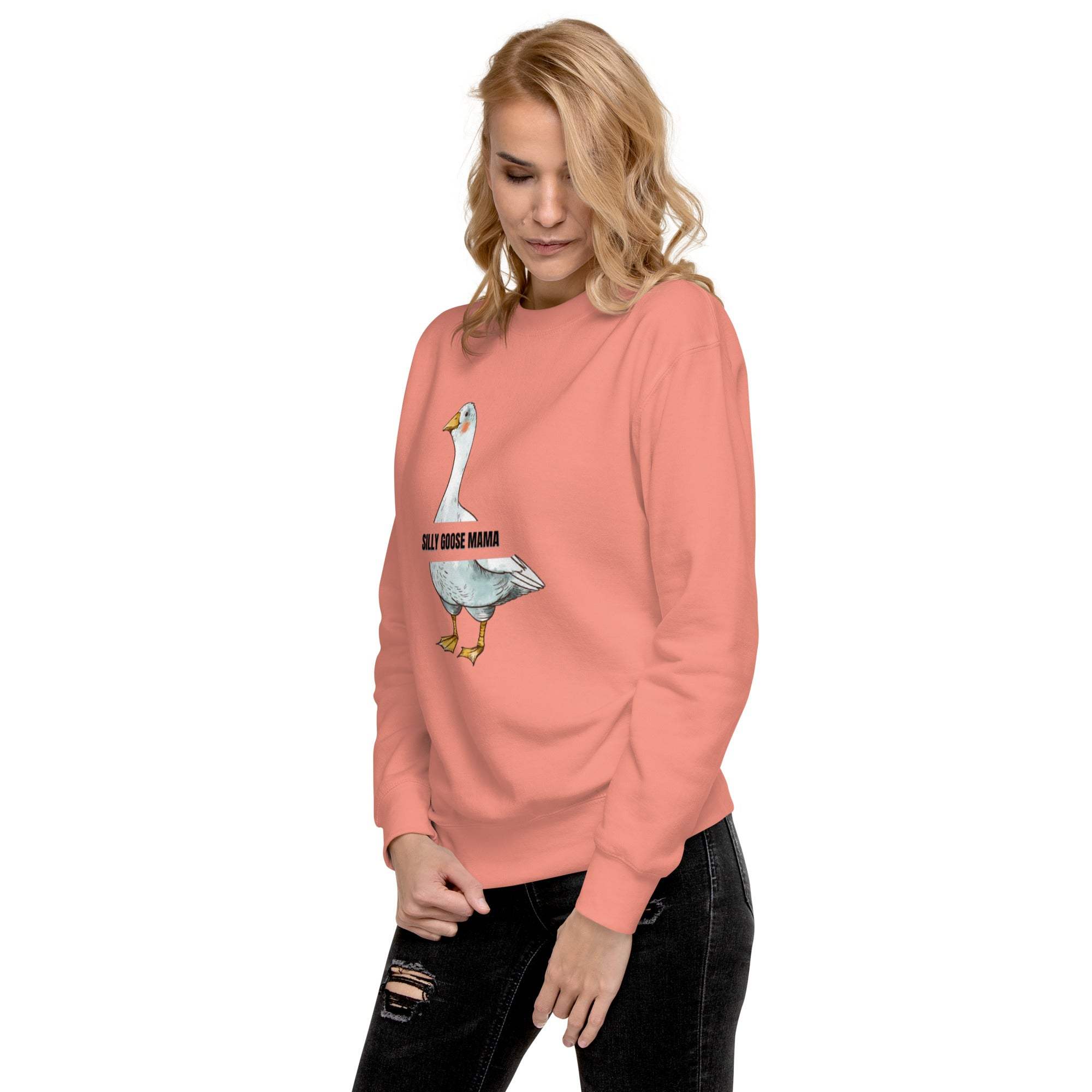 Woman wearing a pink Silly Goose Mama Sweatshirt with a goose graphic and black jeans