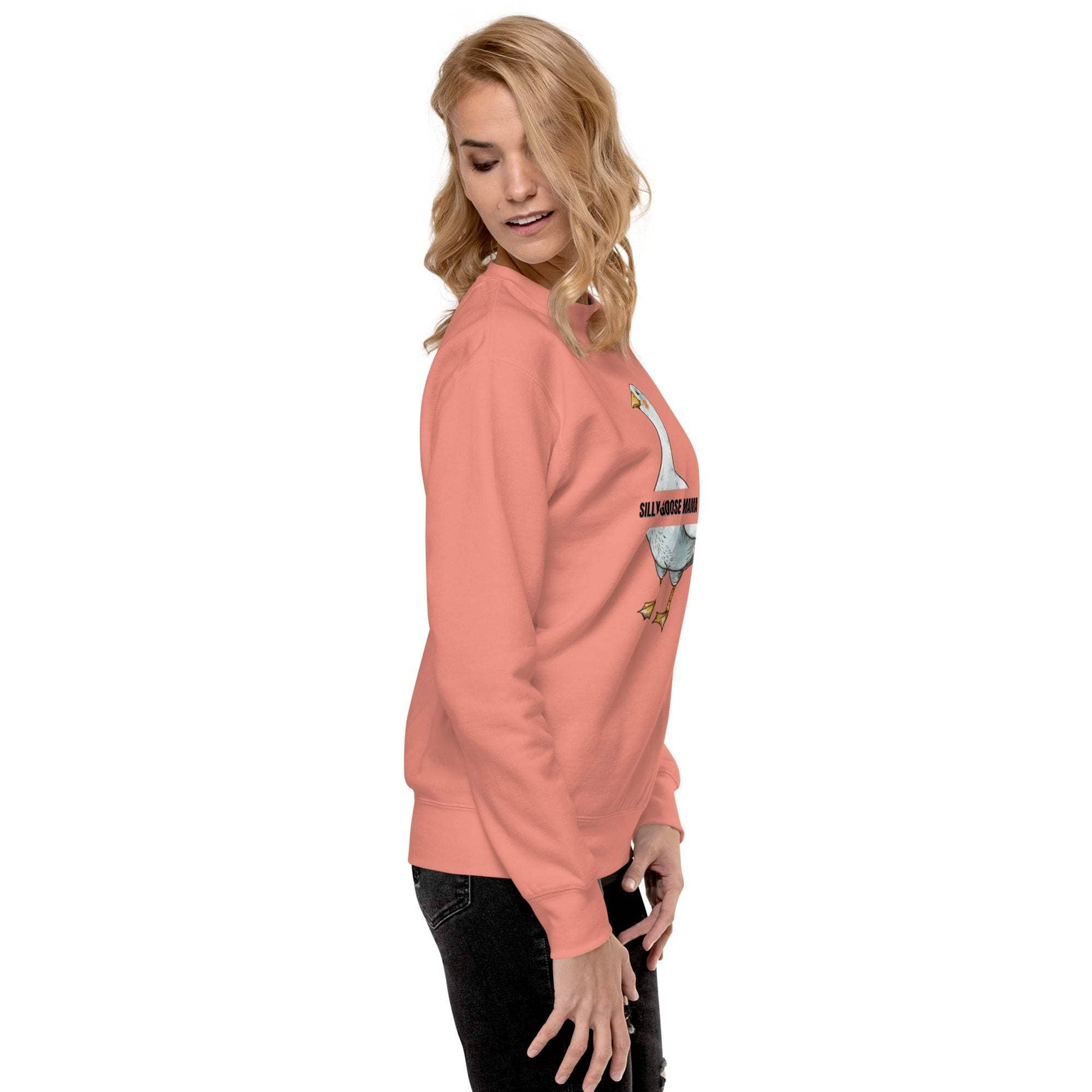 woman wearing pink Silly Goose Mama sweatshirt with goose illustration side view