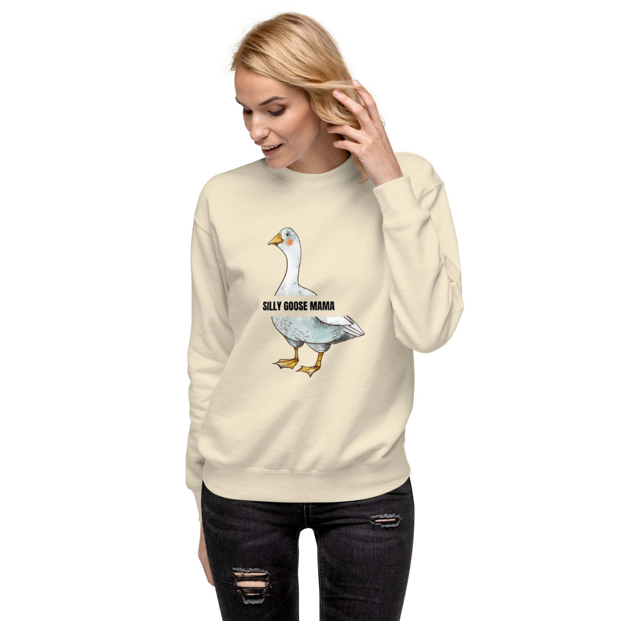Woman wearing a beige Silly Goose Mama Sweatshirt with a playful goose illustration and text on front