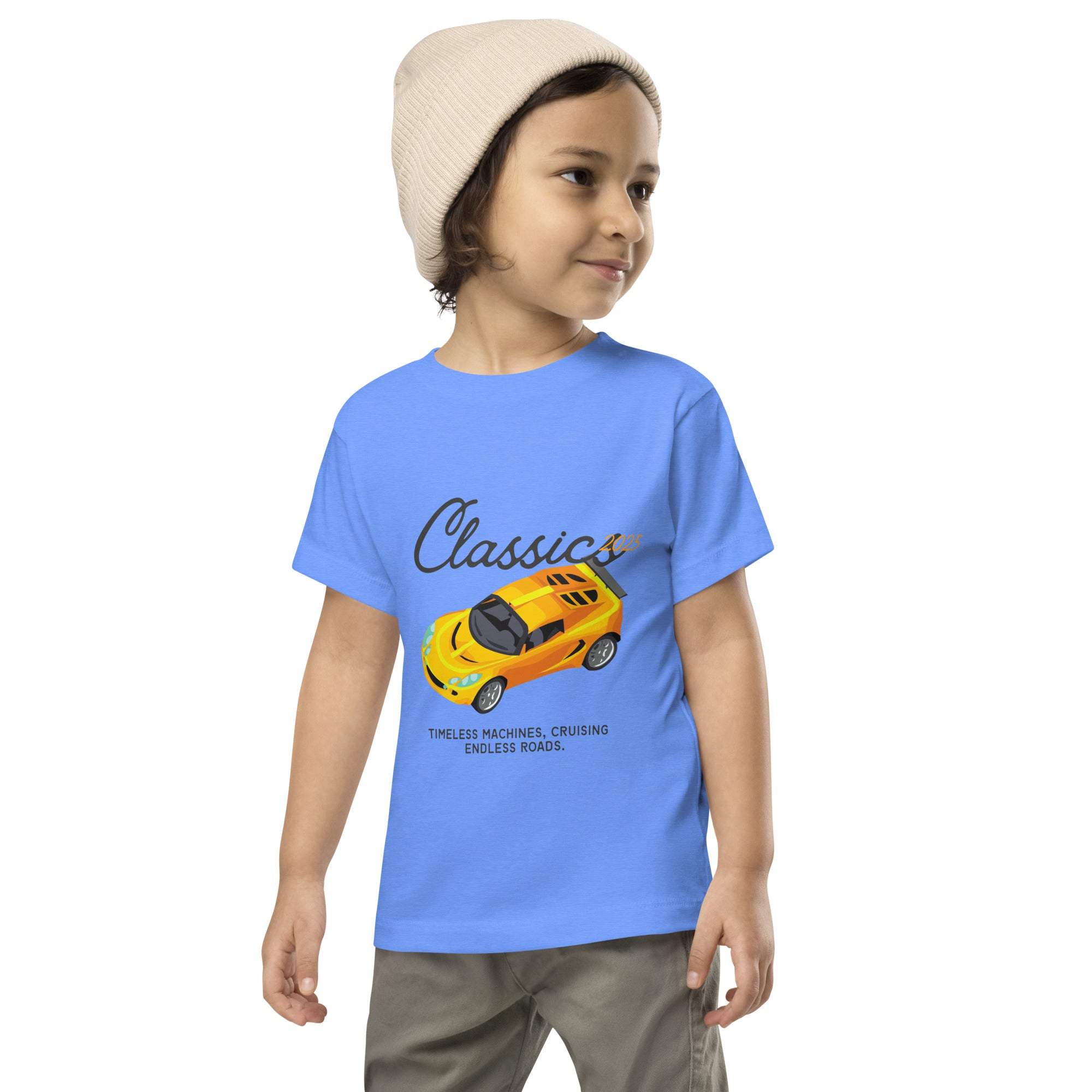Toddler wearing blue Classic Car Kids T-Shirt with yellow vintage sports car design and beanie hat