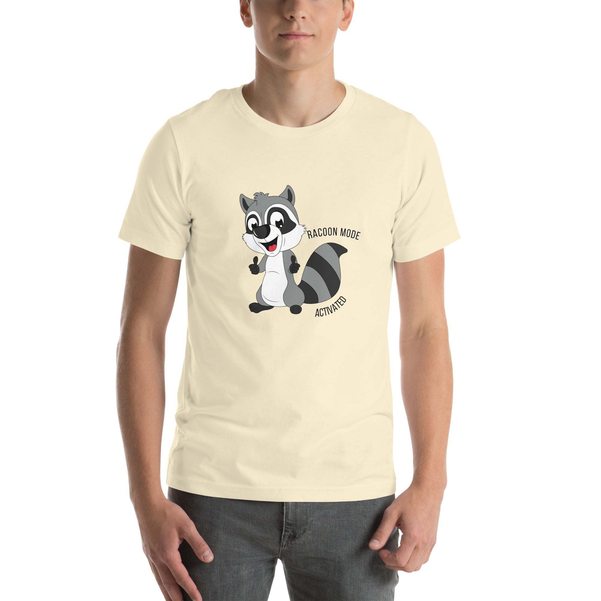 Man wearing cream Raccoon Mode T-Shirt with cartoon raccoon and "Raccoon Mode Activated" text