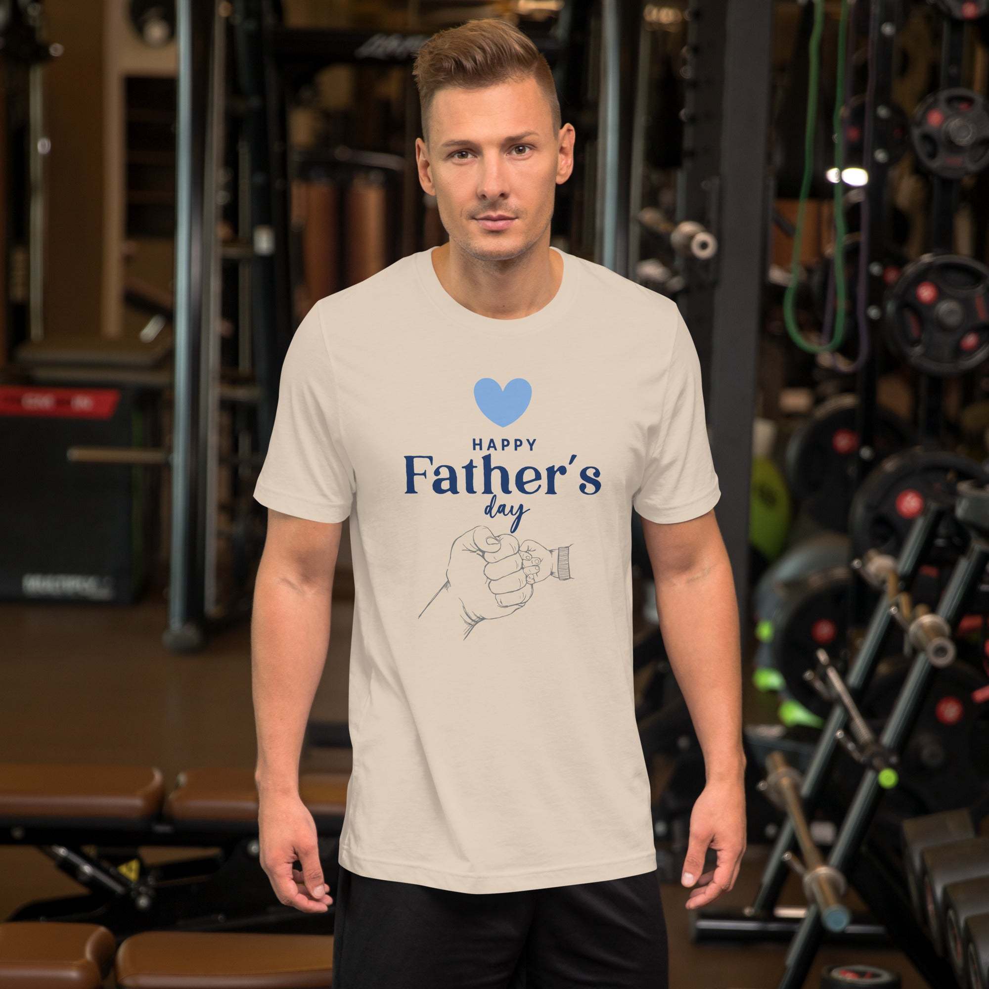 Man wearing white Father's Day T-Shirt with heart and hand design in gym setting