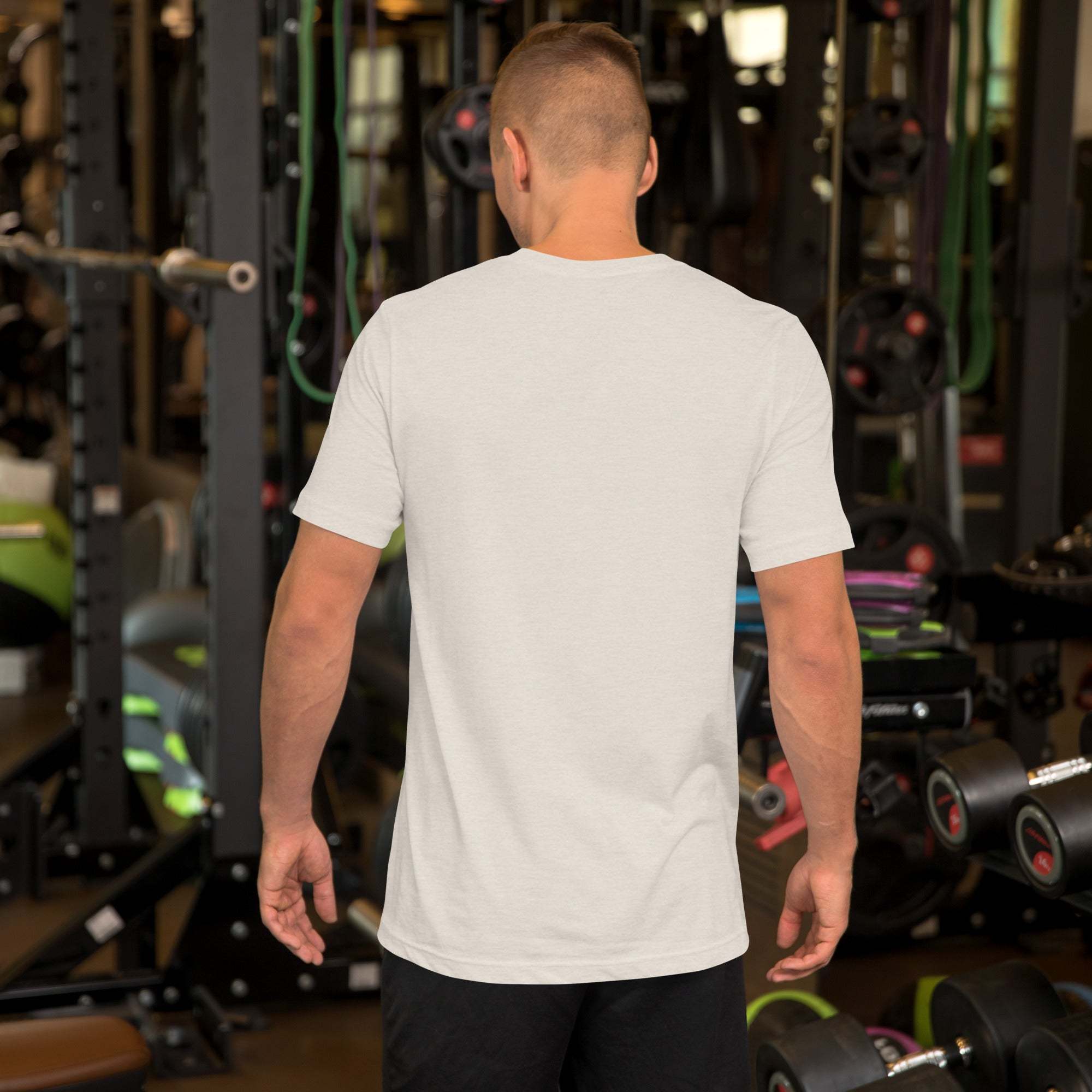 Man wearing white Father's Day T-Shirt with heart and hand design in gym setting