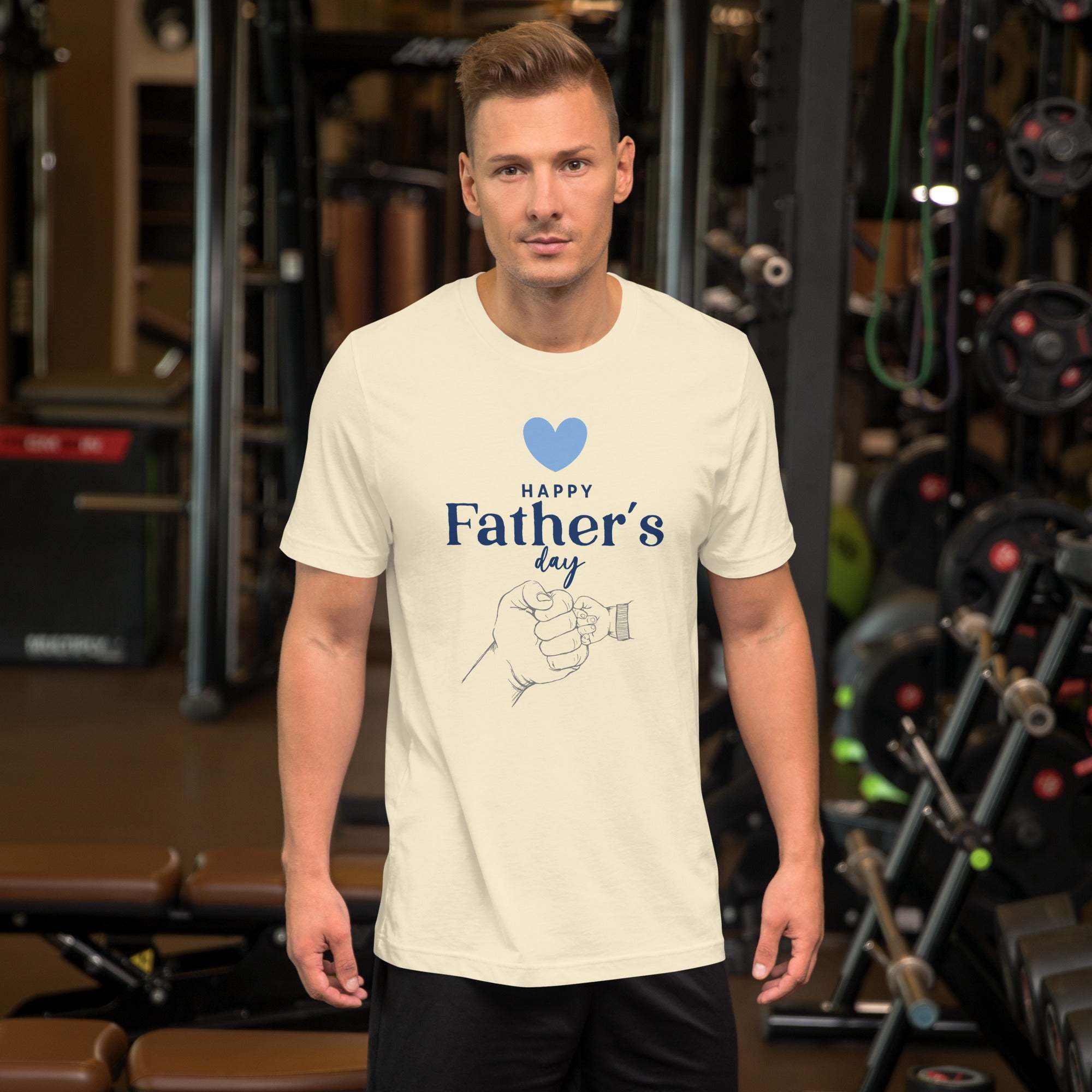 Man wearing cream Happy Father's Day T-Shirt with blue heart and hand design in gym