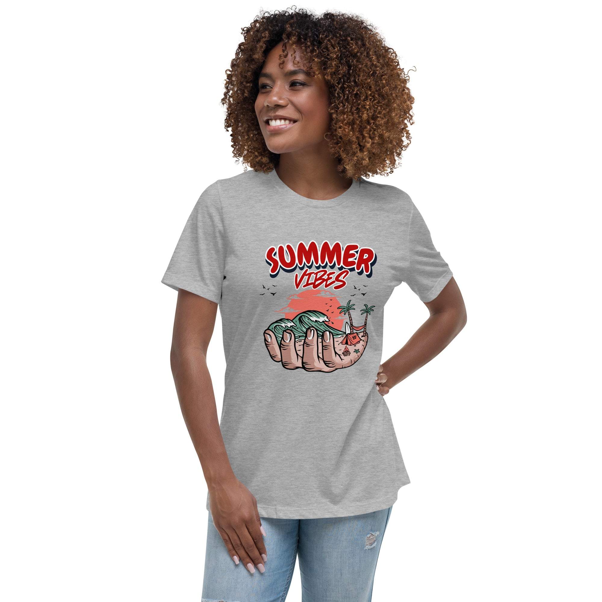 Woman wearing grey Summer Vibes T-Shirt with retro beach graphic held in palm of a hand