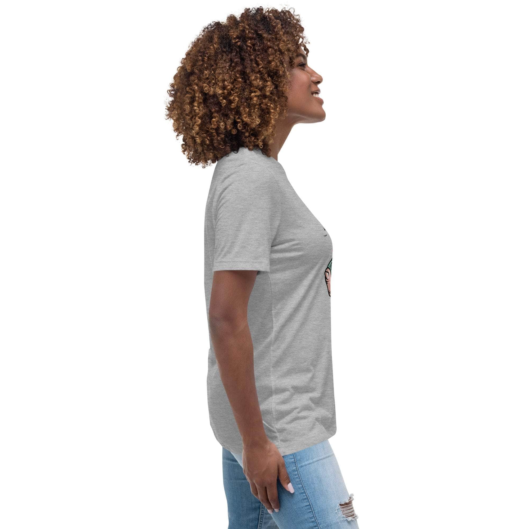 Side view of a woman wearing a grey Summer Vibes T-Shirt with a retro beach graphic, paired with light blue ripped jeans.