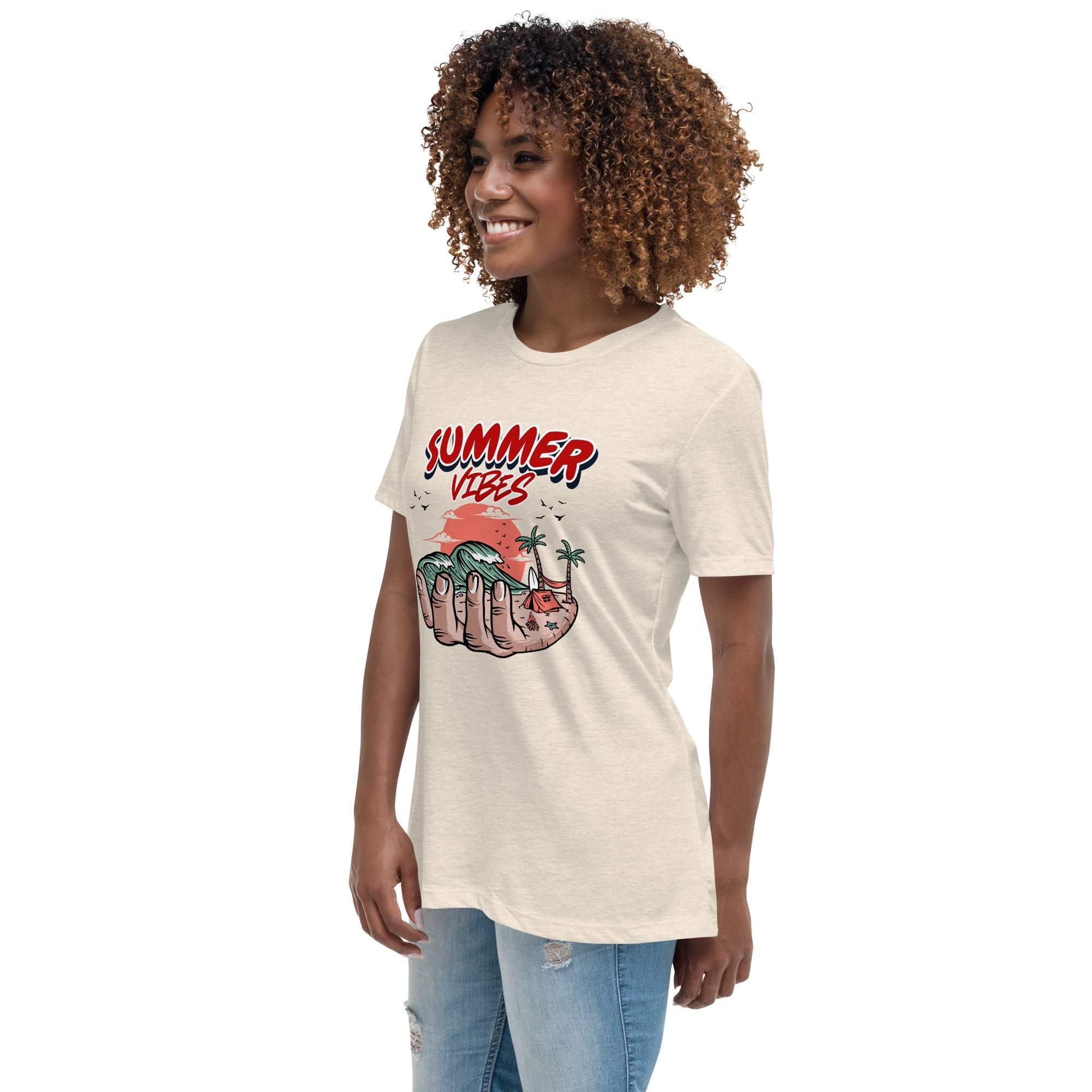 Woman wearing a Summer Vibes T-Shirt with retro beach graphic held in a hand, styled with casual jeans.