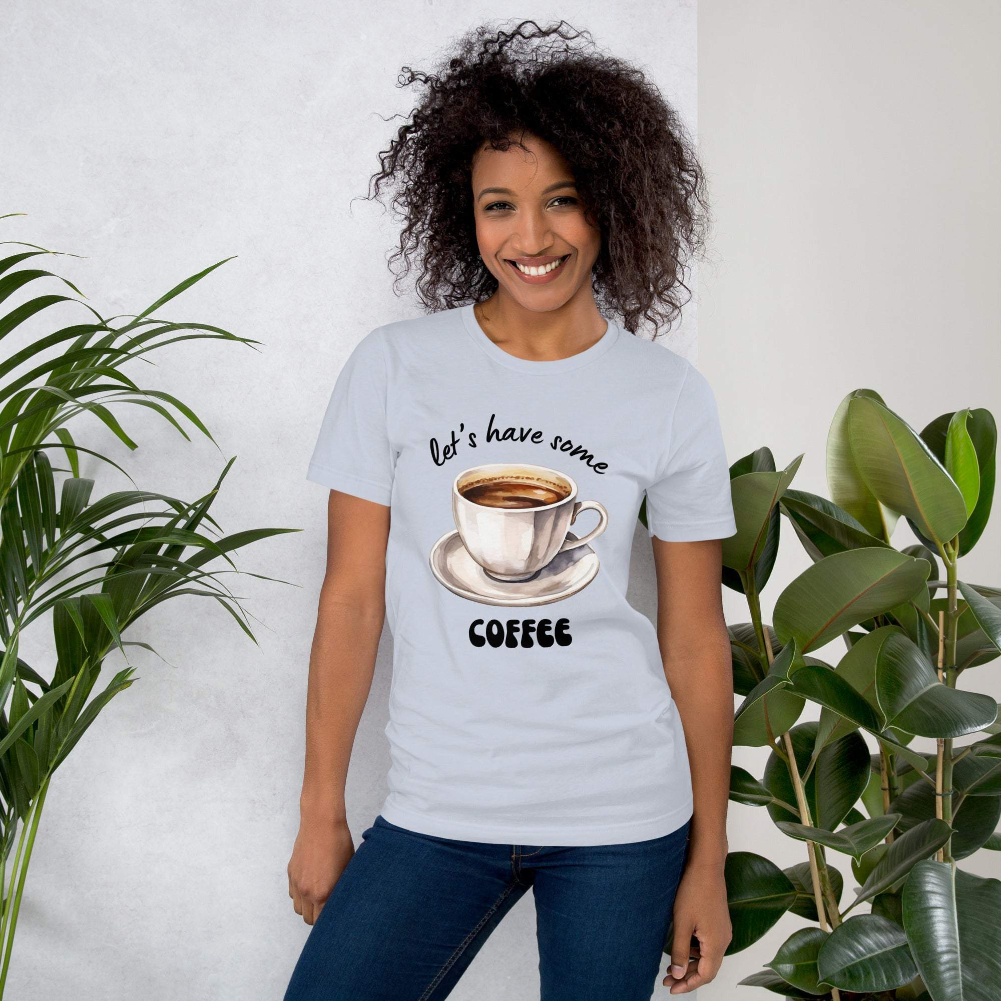 Woman wearing white coffee t-shirt with "Let's Have Some Coffee" and coffee cup design