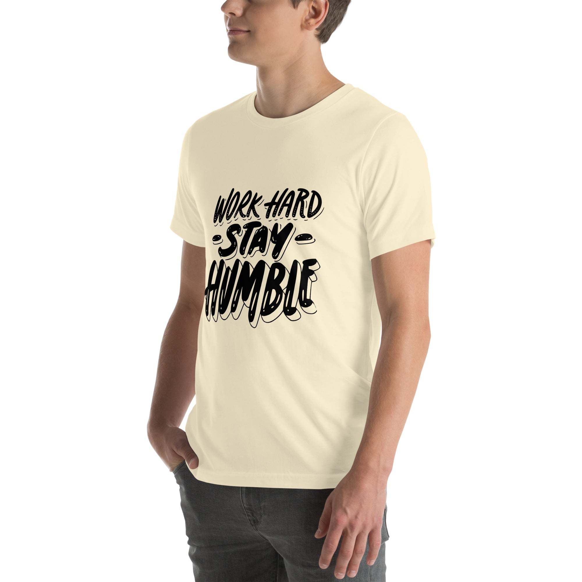 Man wearing beige Work Hard Stay Humble T-Shirt with bold black motivational text design