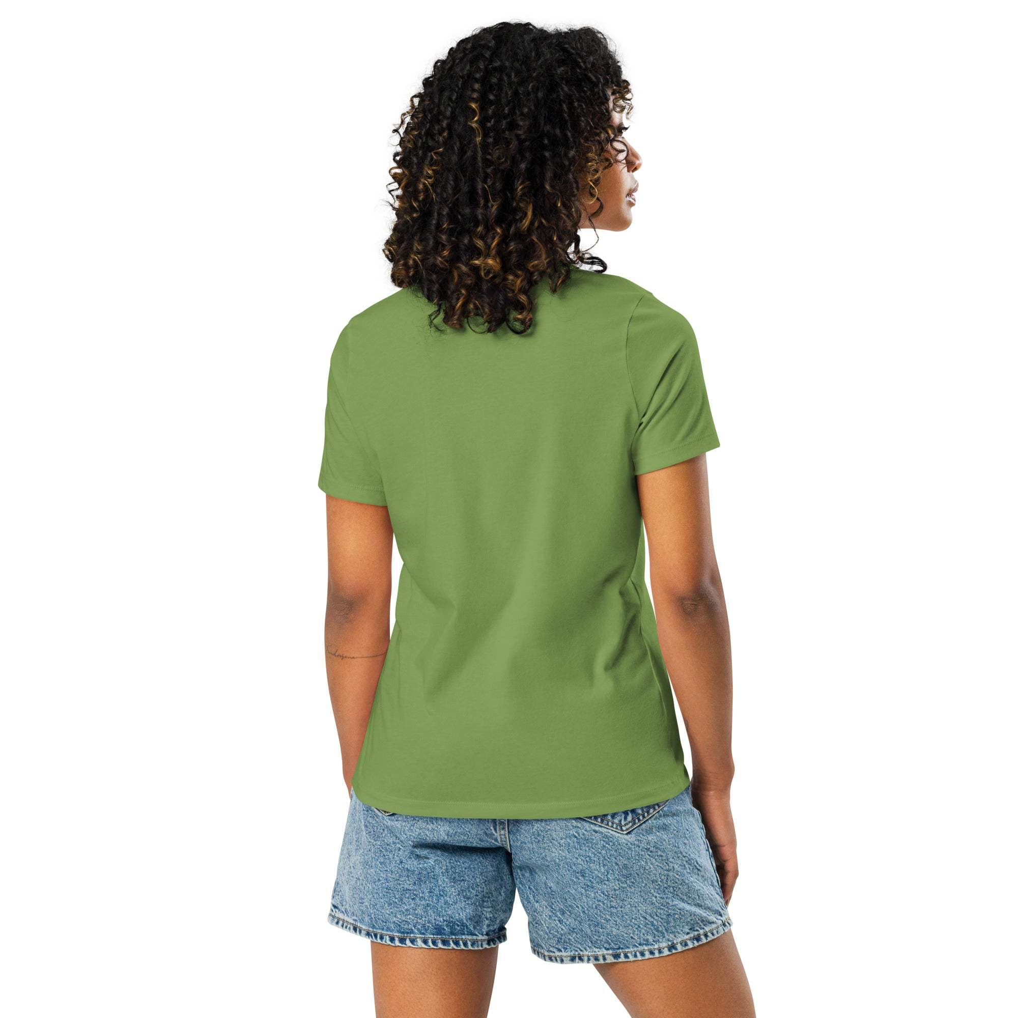 Back view of woman wearing green Adventure Awaits T-Shirt with denim shorts