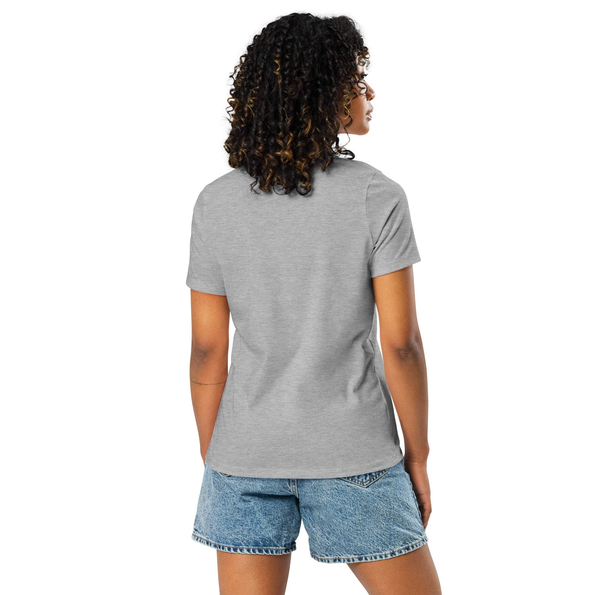 Woman wearing gray Adventure Awaits T-Shirt with off-road desert sunset design, shown from the back