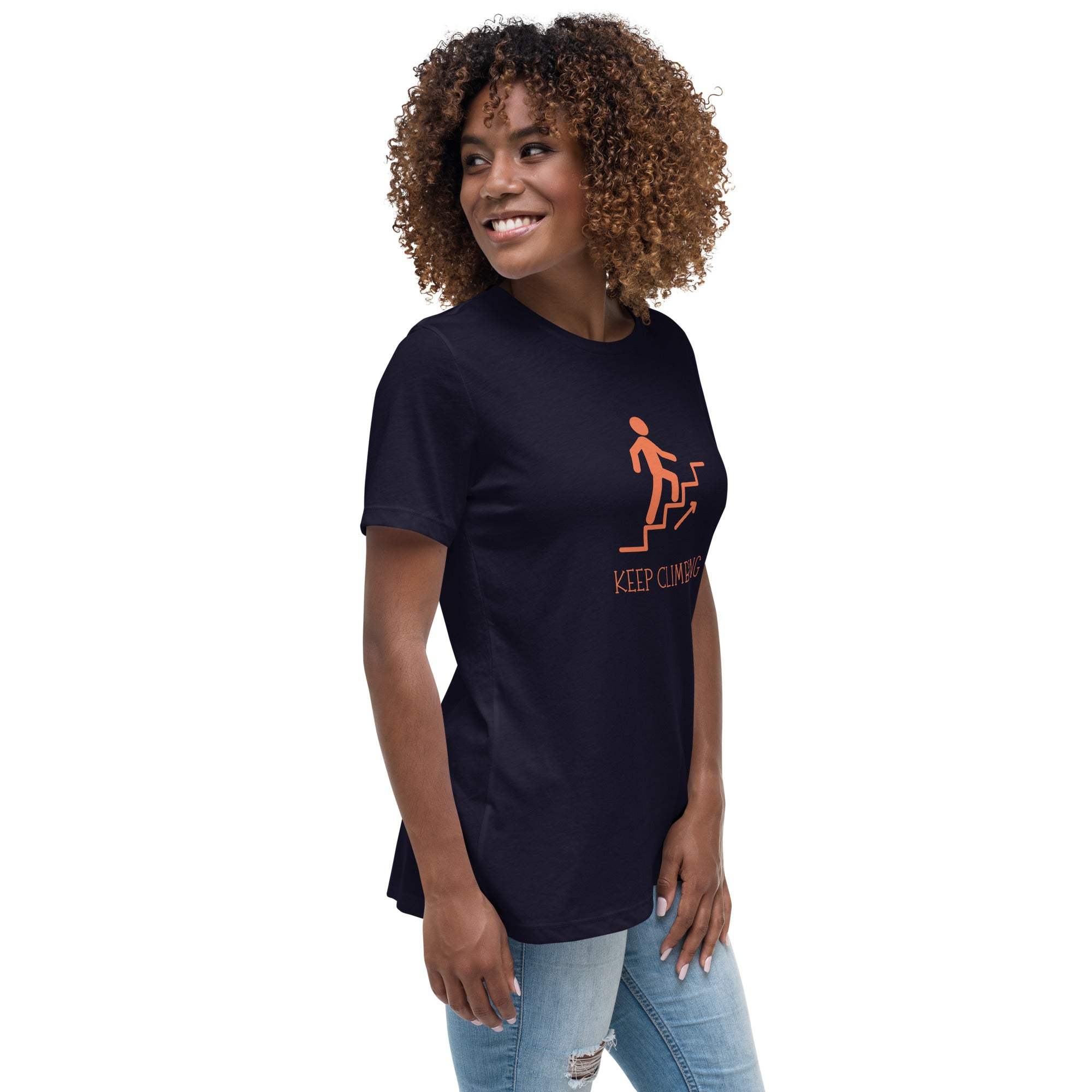 Woman wearing black Keep Climbing motivational graphic t-shirt with orange design and jeans