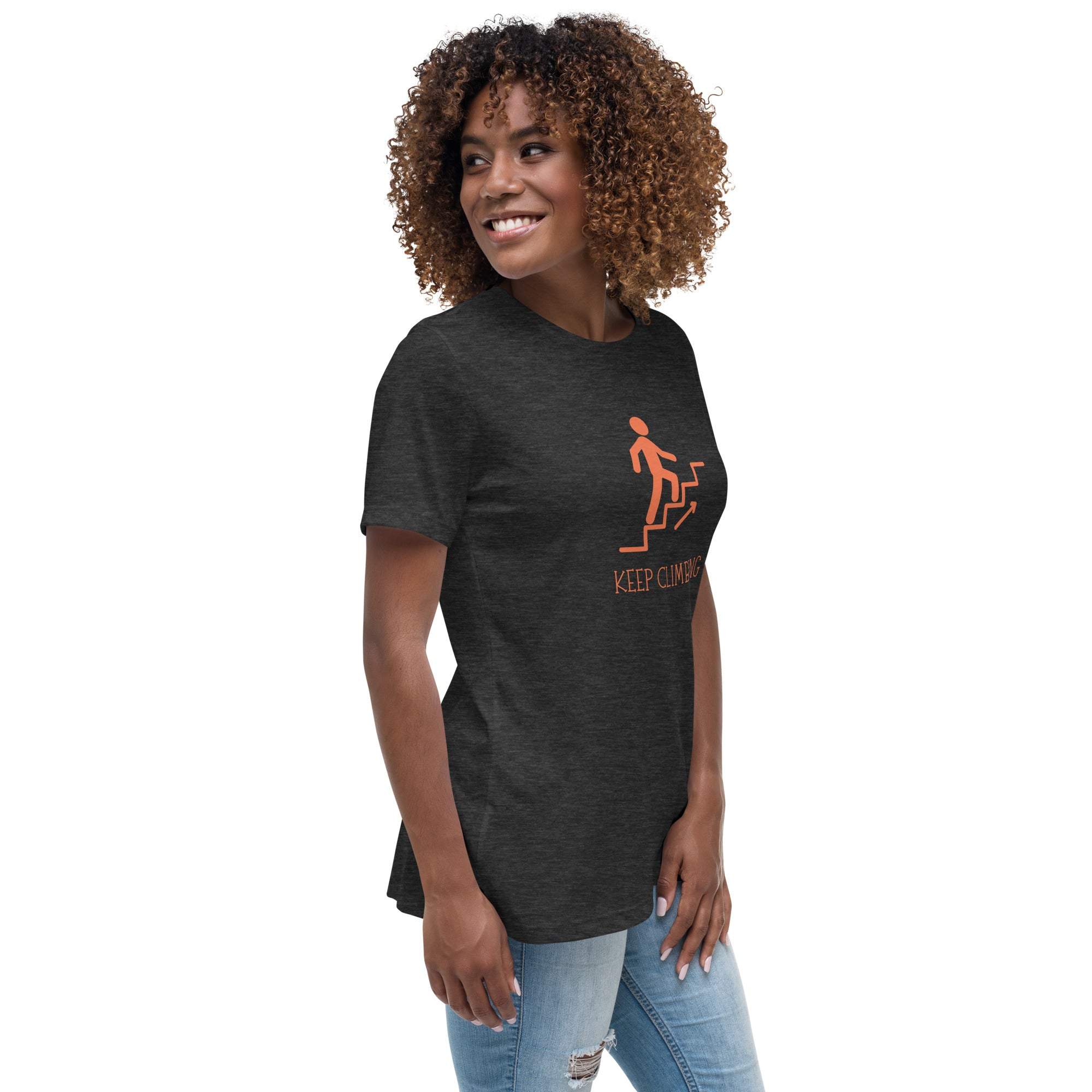 Woman wearing black "Keep Climbing" motivational graphic t-shirt with stairs design and casual jeans