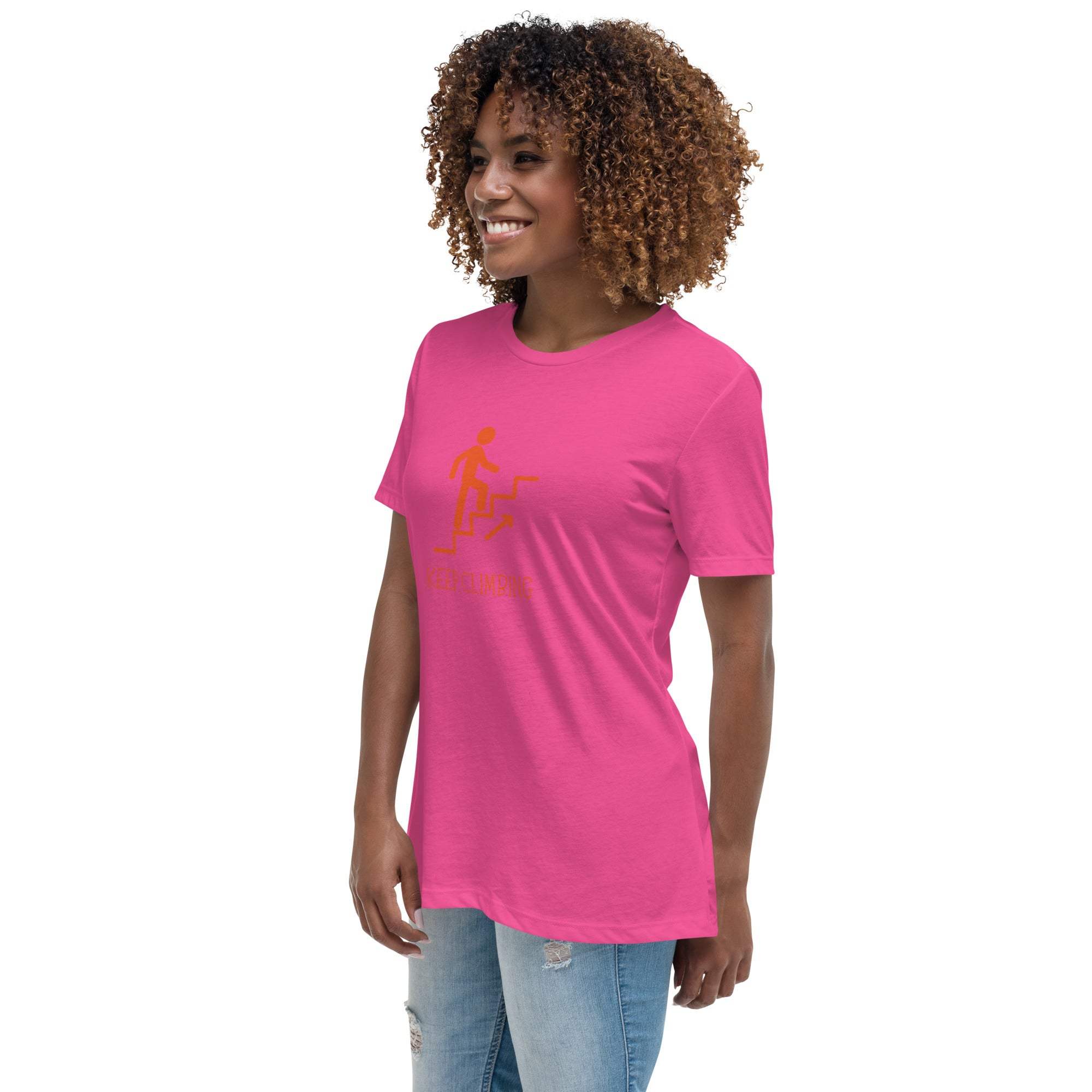 Woman wearing pink Keep Climbing Women's T-Shirt with motivational graphic, styled casually with jeans.