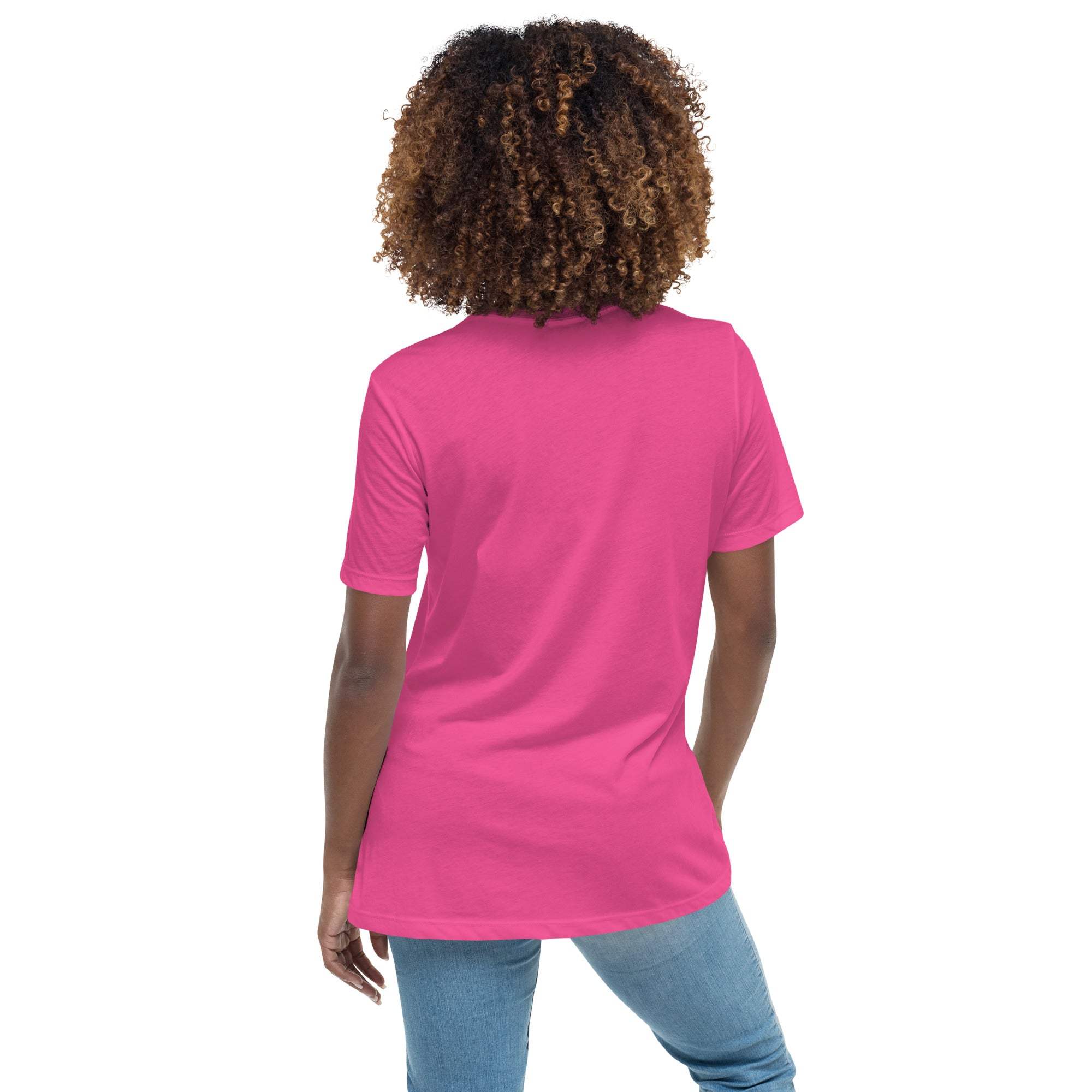 Back view of a woman wearing a bright pink Keep Climbing women's t-shirt paired with blue jeans