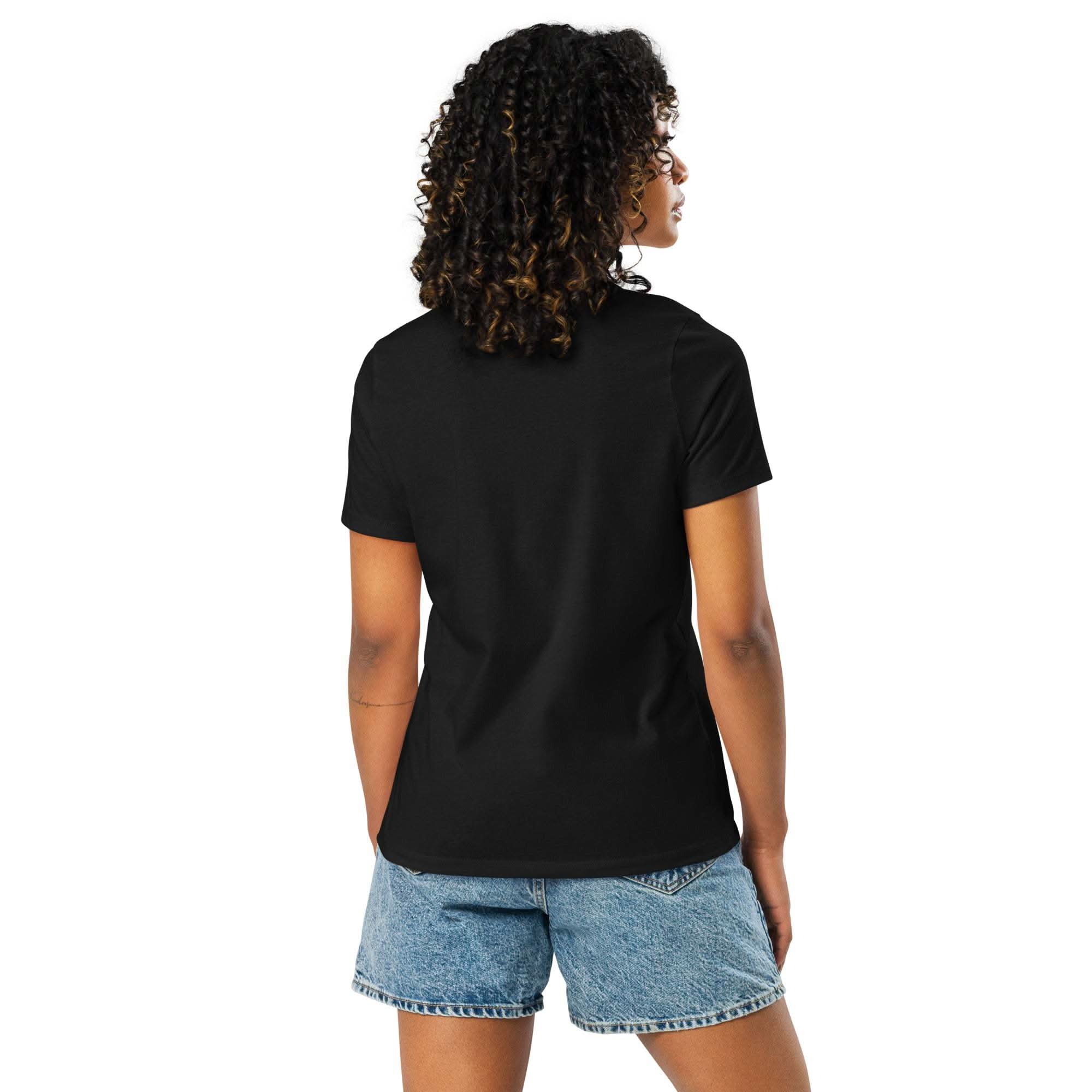 Woman wearing black LIVE LOUD Music T-Shirt with retro design, paired with denim shorts, back view