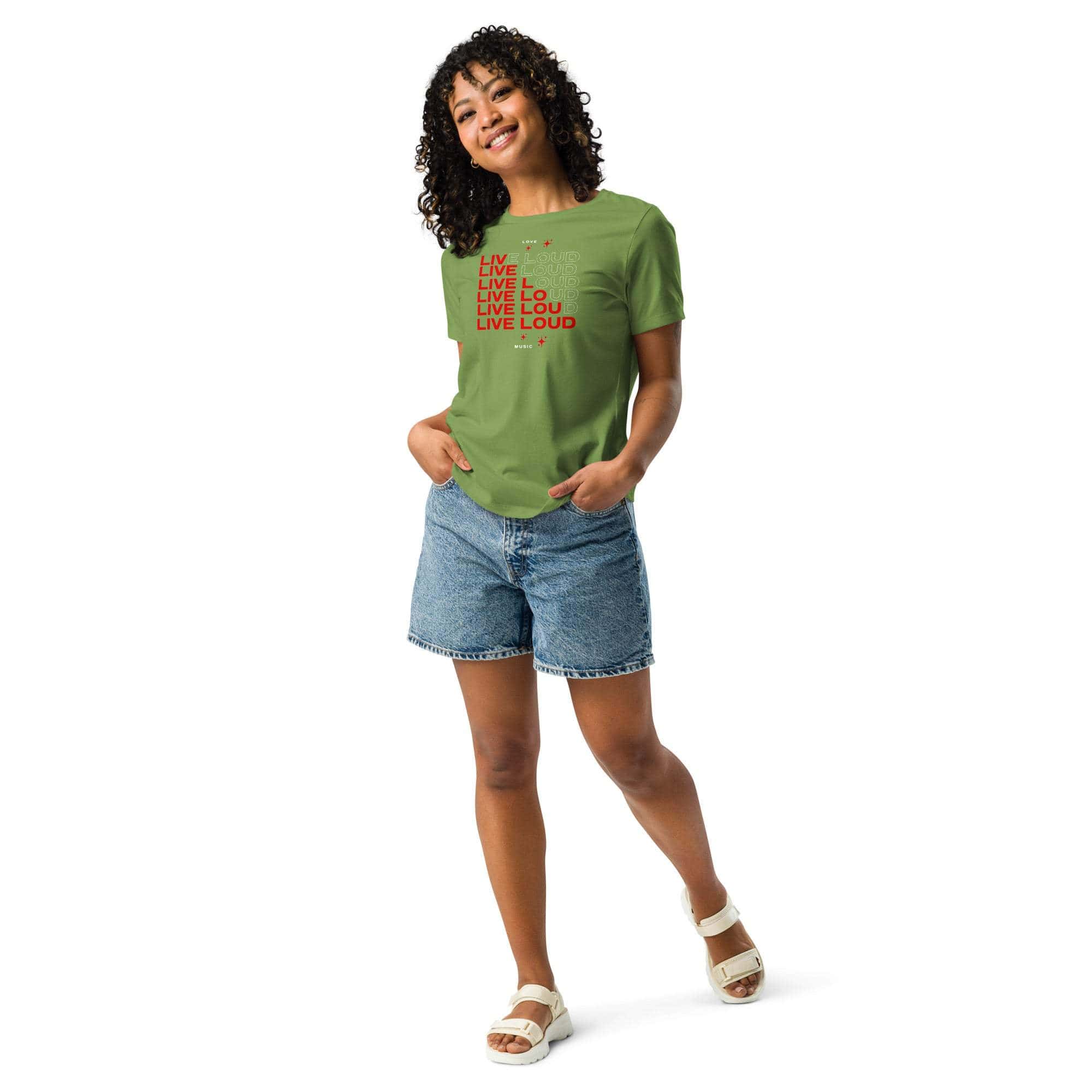 Woman wearing green LIVE LOUD Music T-Shirt with red retro typography paired with denim shorts and white sandals